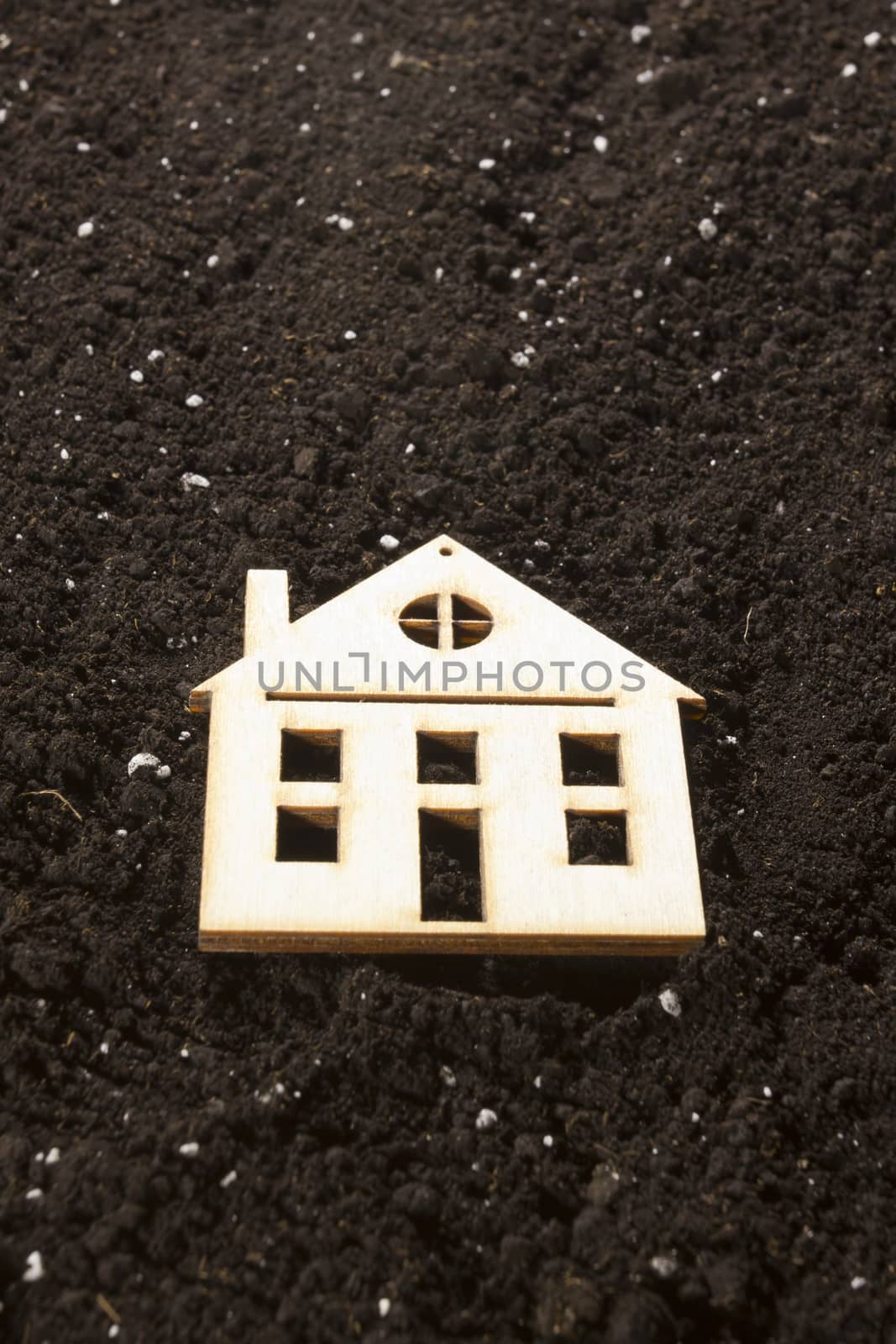 Model of a house in the background of a dug ground