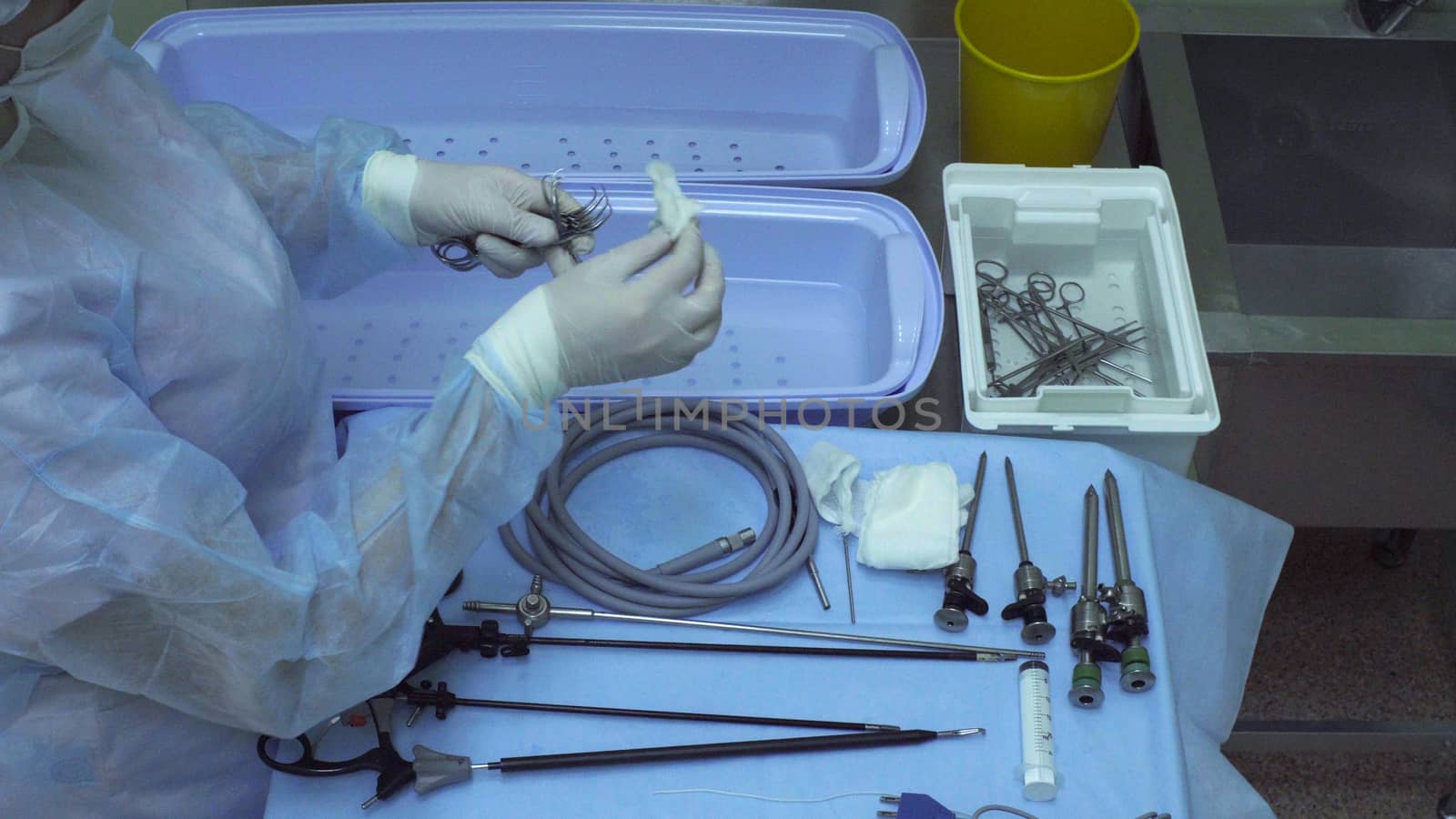 The surgical nurse washing medical instrument by Chudakov