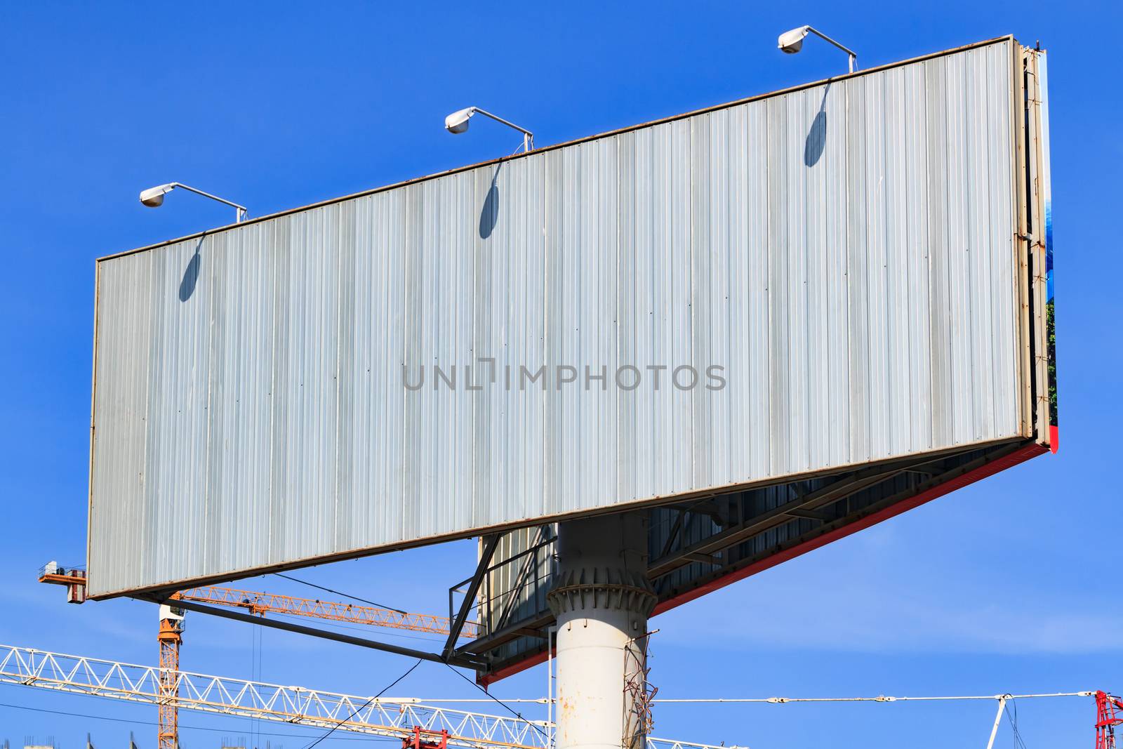 Large blank billboard with blue sky behind it.