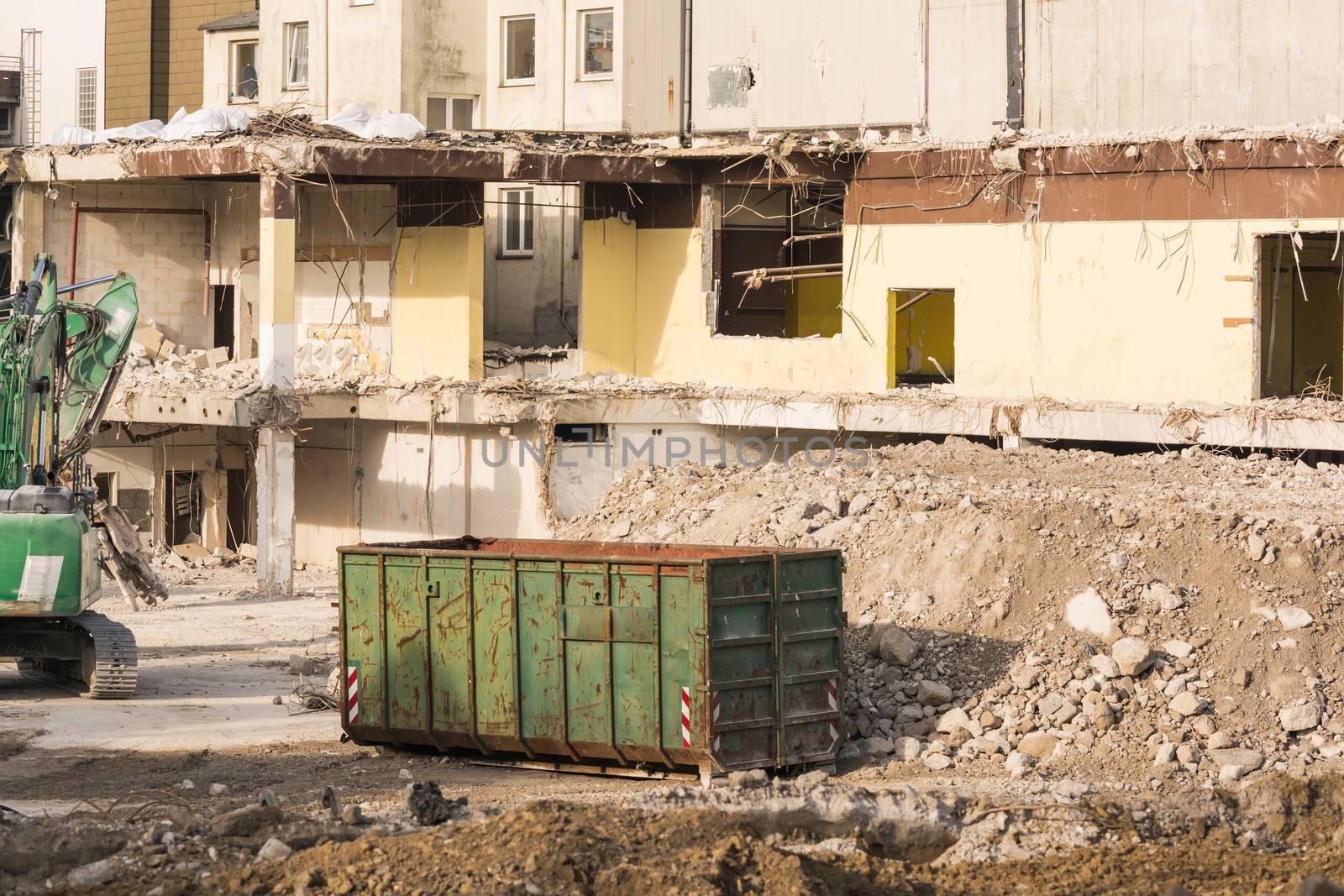 Excavator in front of a demolition site