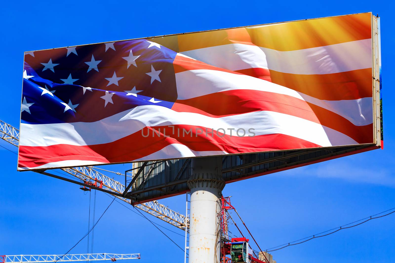 Large billboard with the USA american flag with blue sky behind it.