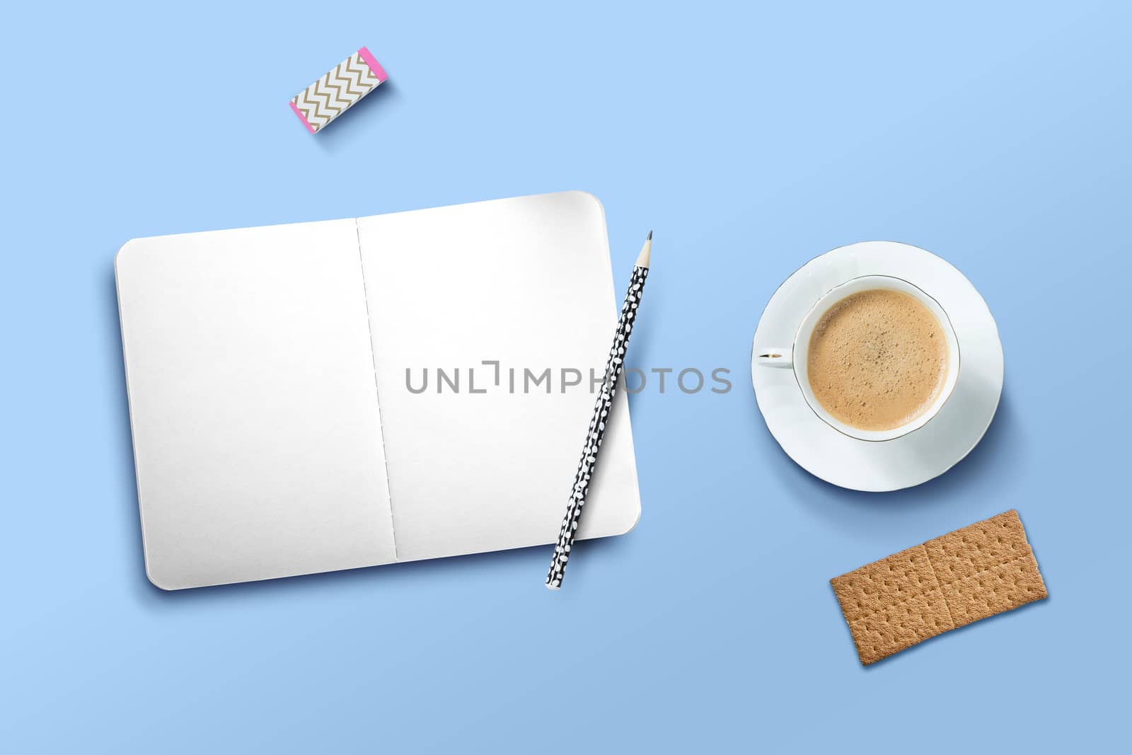 Composition with a cup of coffee, biscuits and an empty notebook