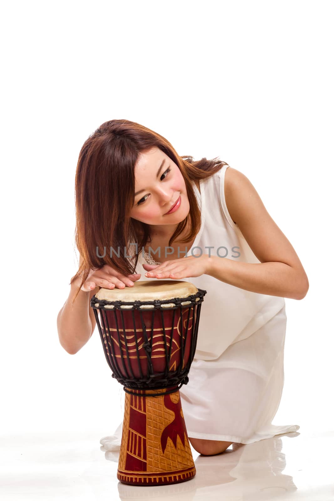Chinese woman playing a djembe hand drum