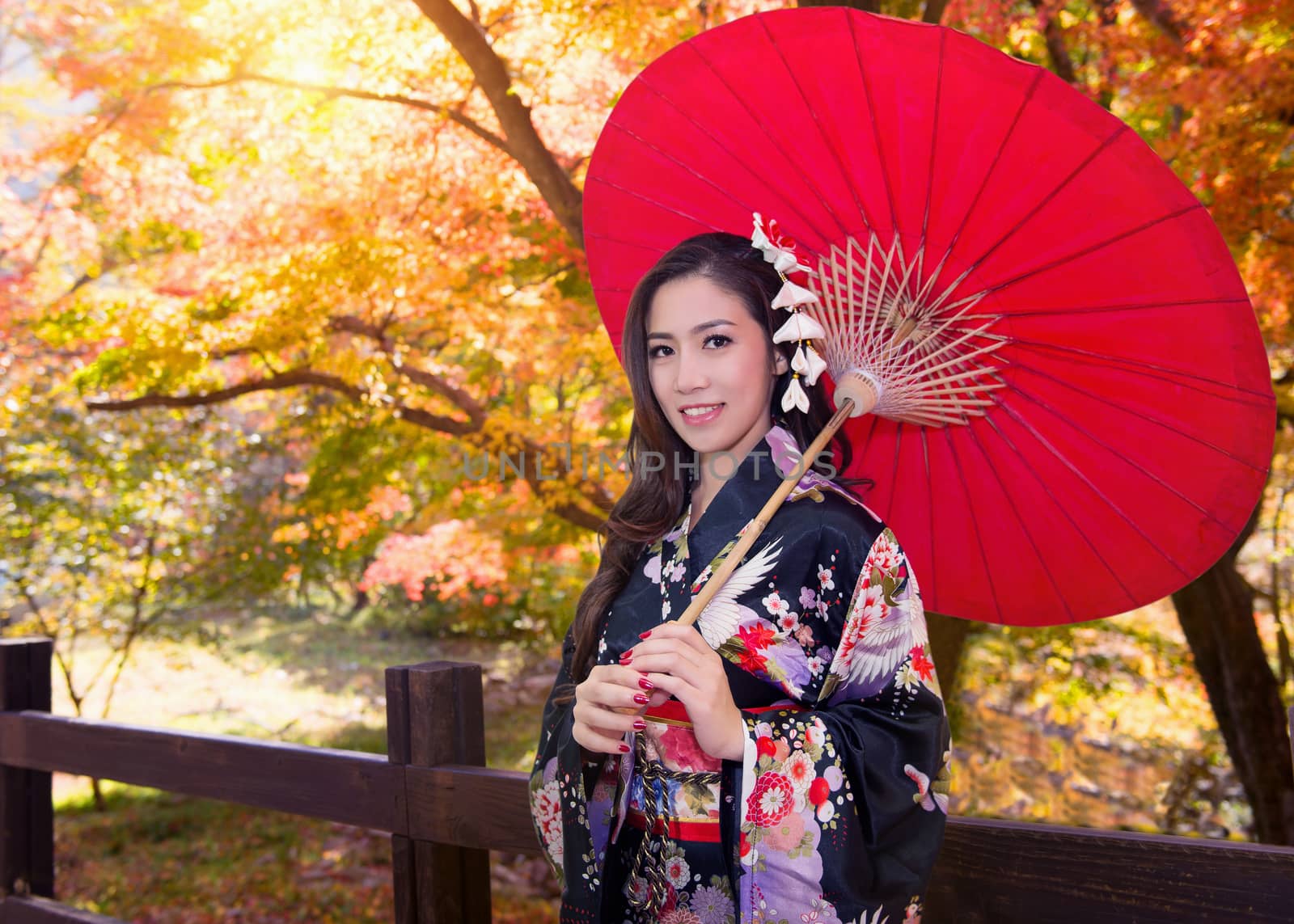 Asian woman wearing traditional japanese kimono with red umbrella in autumn. by gutarphotoghaphy