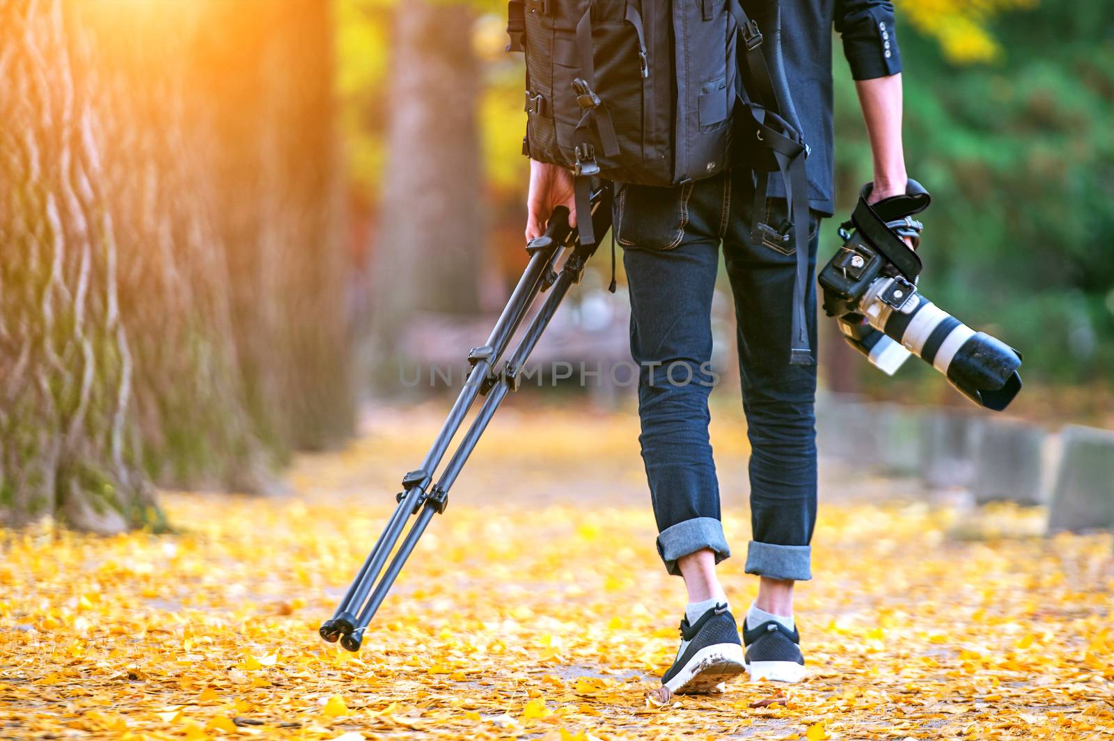 professional photographer with camera and tripod in autumn. by gutarphotoghaphy
