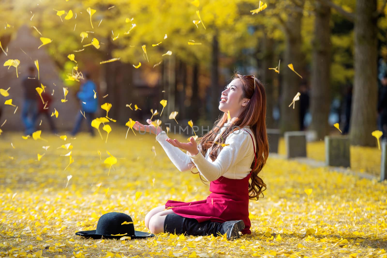 Beautiful Girl with Yellow Leaves in Nami Island, Korea. Nami island in autumn.