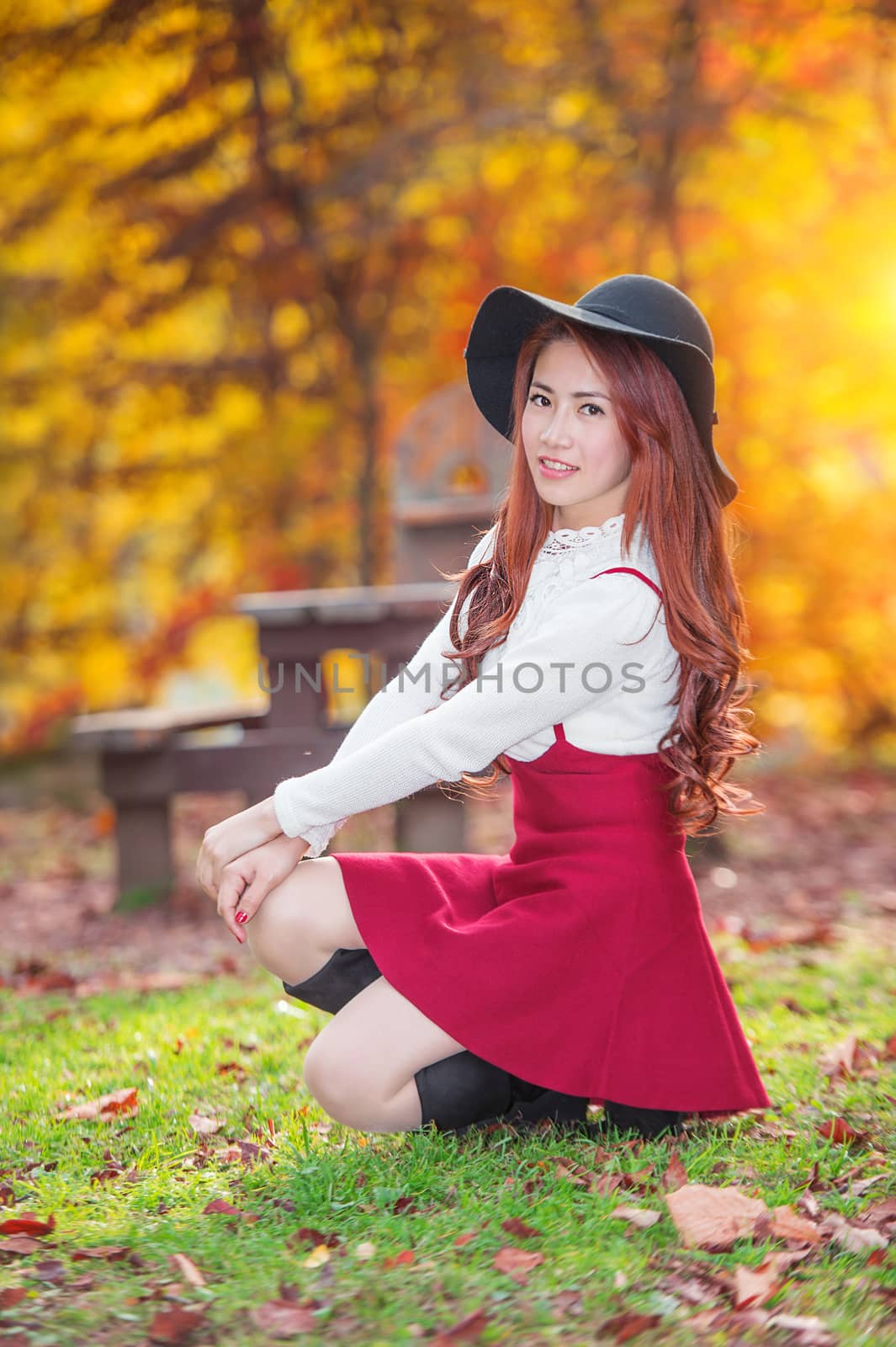 Young woman with autumn leaves in maple garden. by gutarphotoghaphy