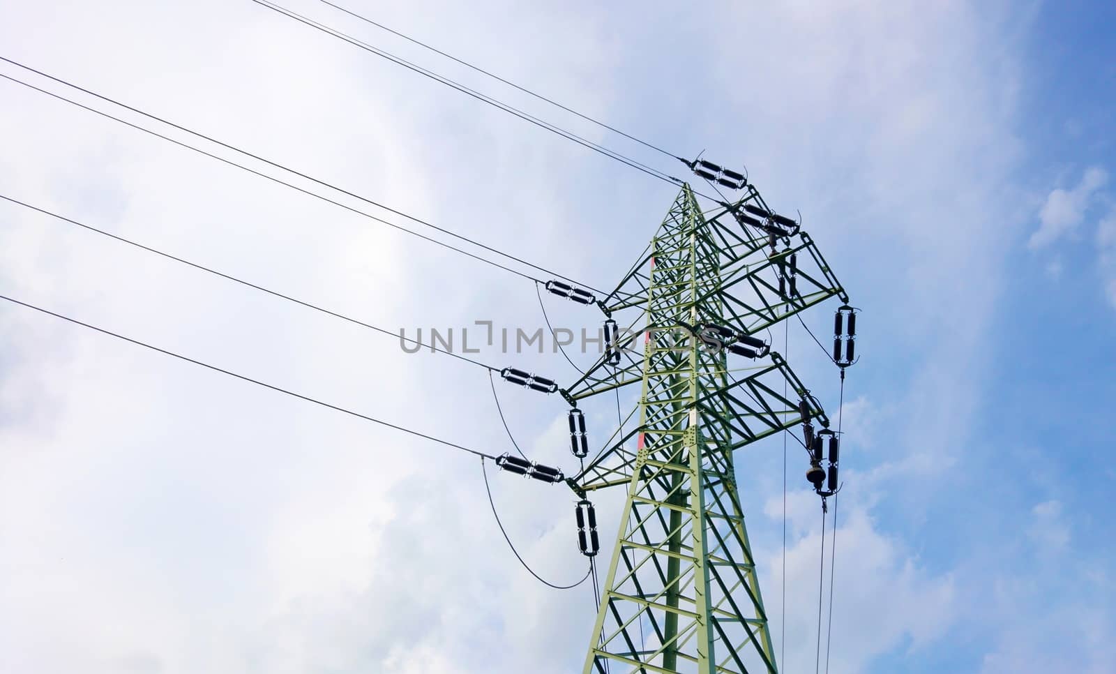 Low angle view of a power line pole with blue sky and clouds.