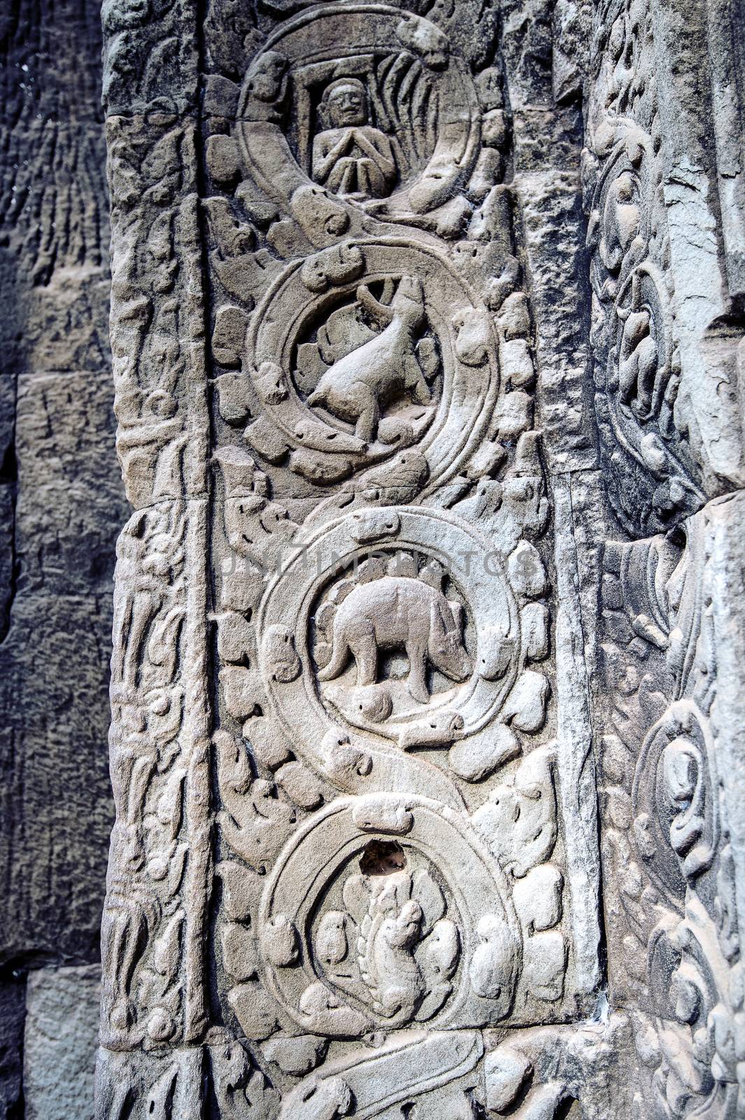 sculpted stone depicting a dinosaur at the ancient Ta Prohm temple at Angkor Wat, Siem Reap, Cambodia. by gutarphotoghaphy