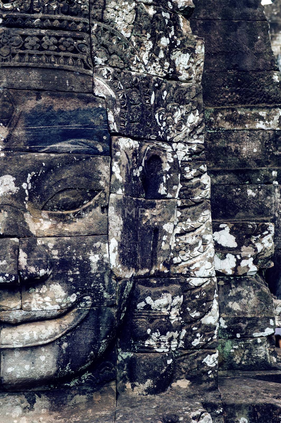 Ancient stone faces of Bayon temple, Angkor Wat, Siam Reap, Cambodia.