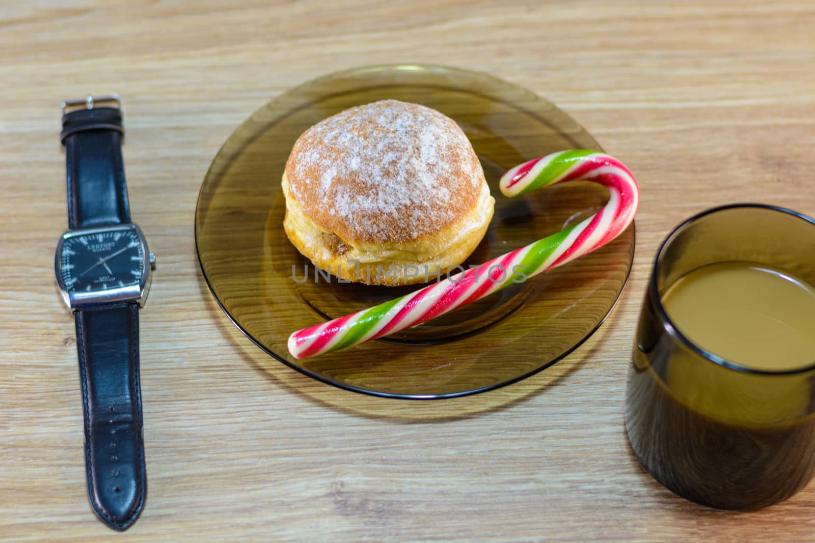 on the plate of a bun and candy along with coffee.