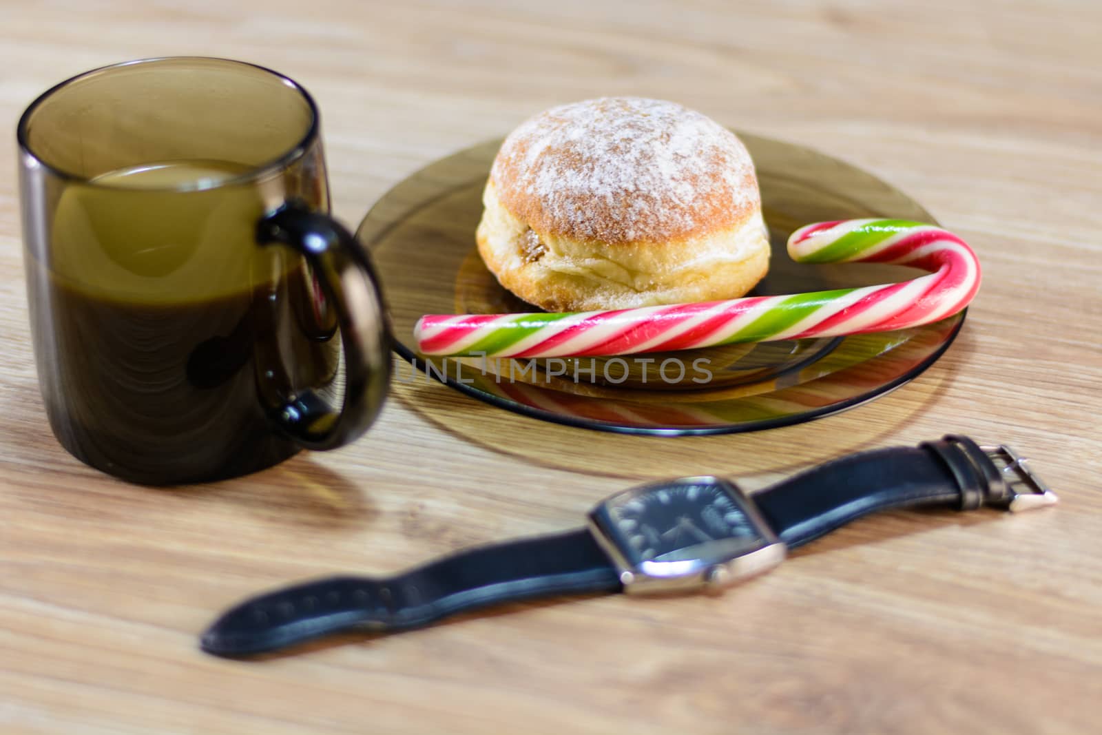 on the plate of a bun and candy along with coffee.