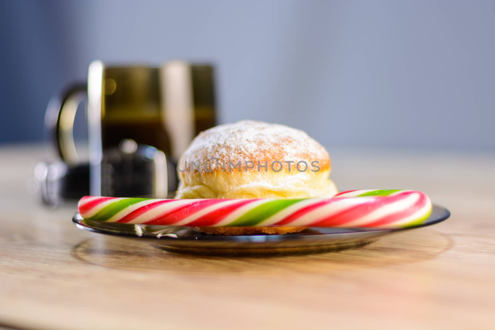 on the plate of a bun and candy along with coffee.