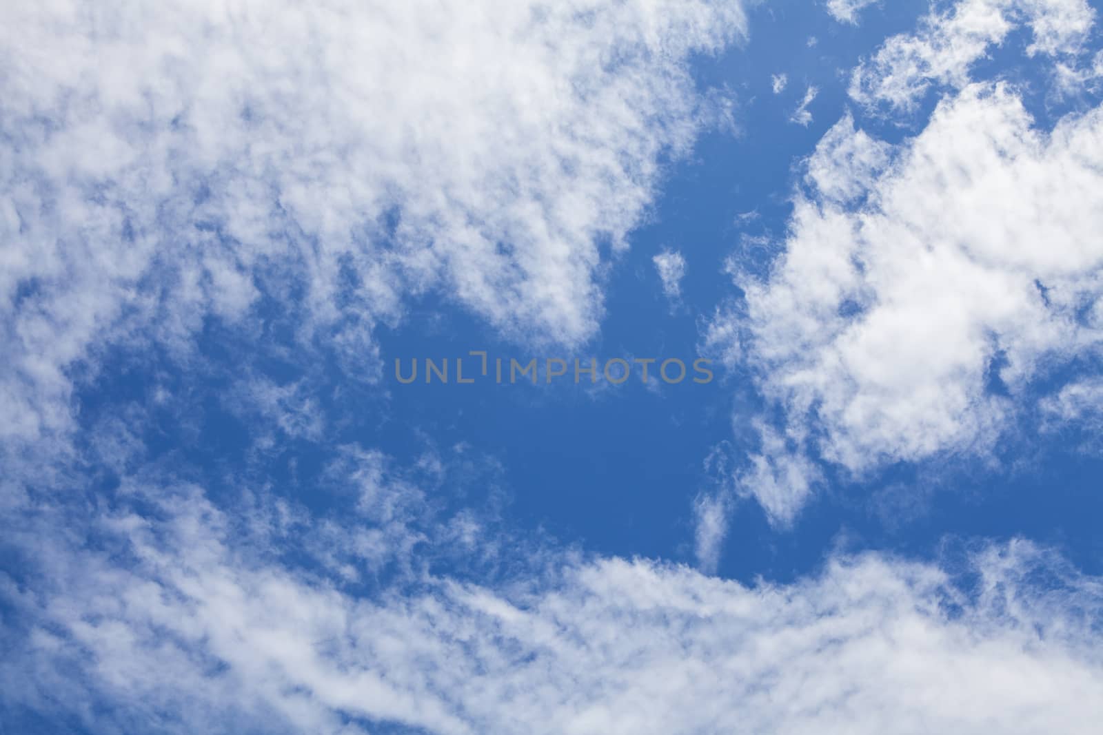 Blue sky background with white clouds and rain clouds. The vast blue sky and clouds sky on sunny day. 