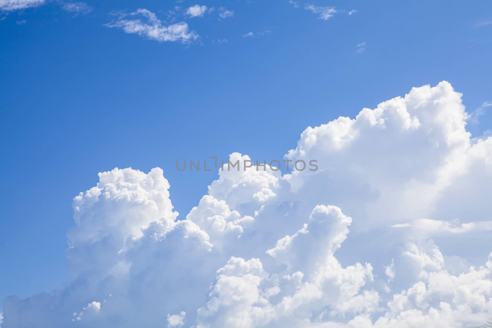 Blue sky background with white clouds and rain clouds. The vast blue sky and clouds sky on sunny day. 