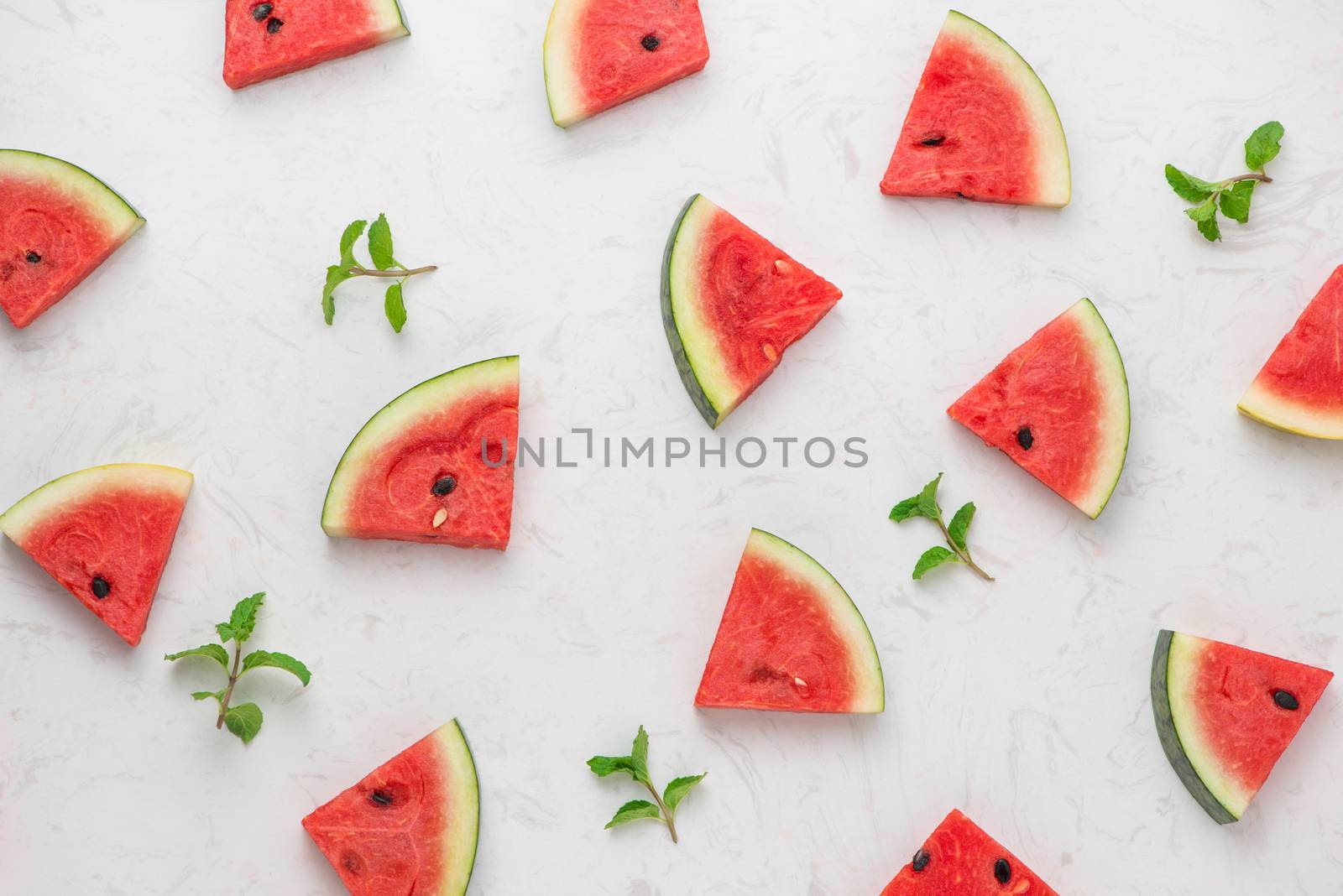 Fresh sliced watermelon on marble table in summertime