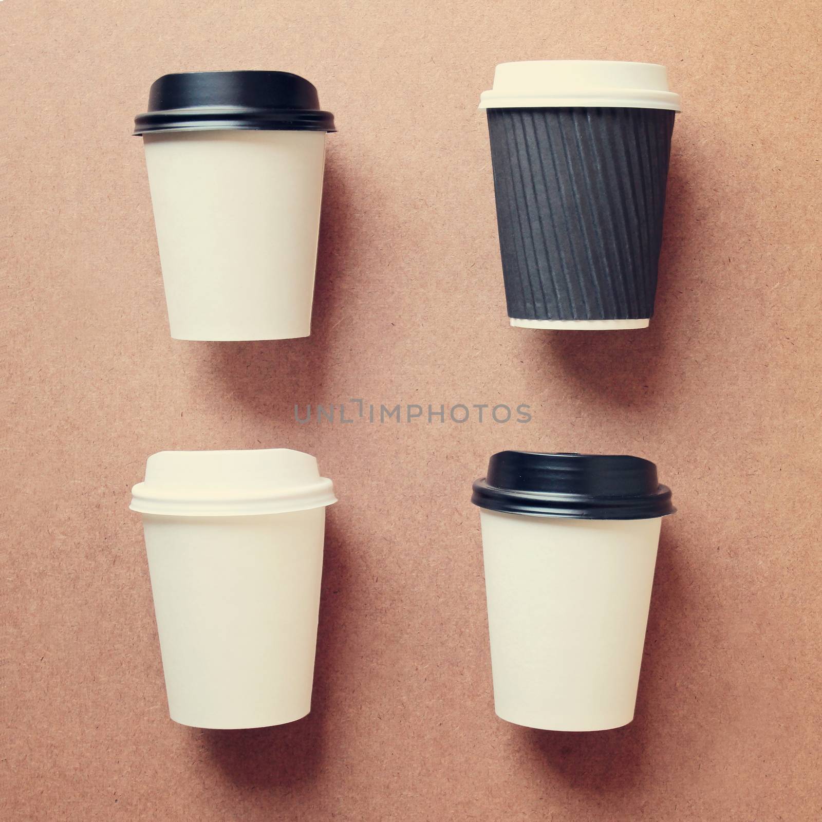 Set of four paper cups for coffee or tea in different foreshortening. by boys1983@mail.ru