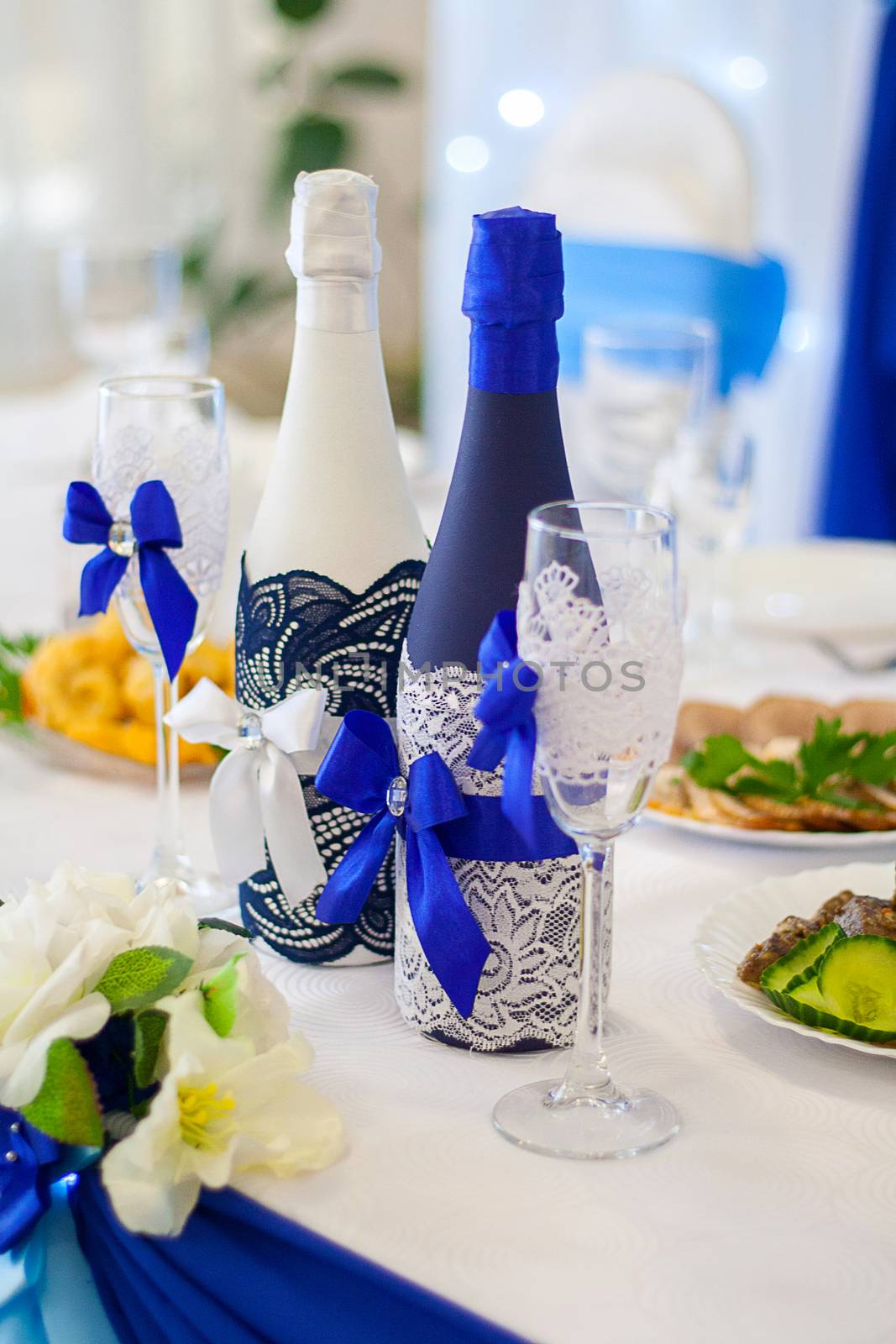 Two bottles of champagne decorated for a wedding