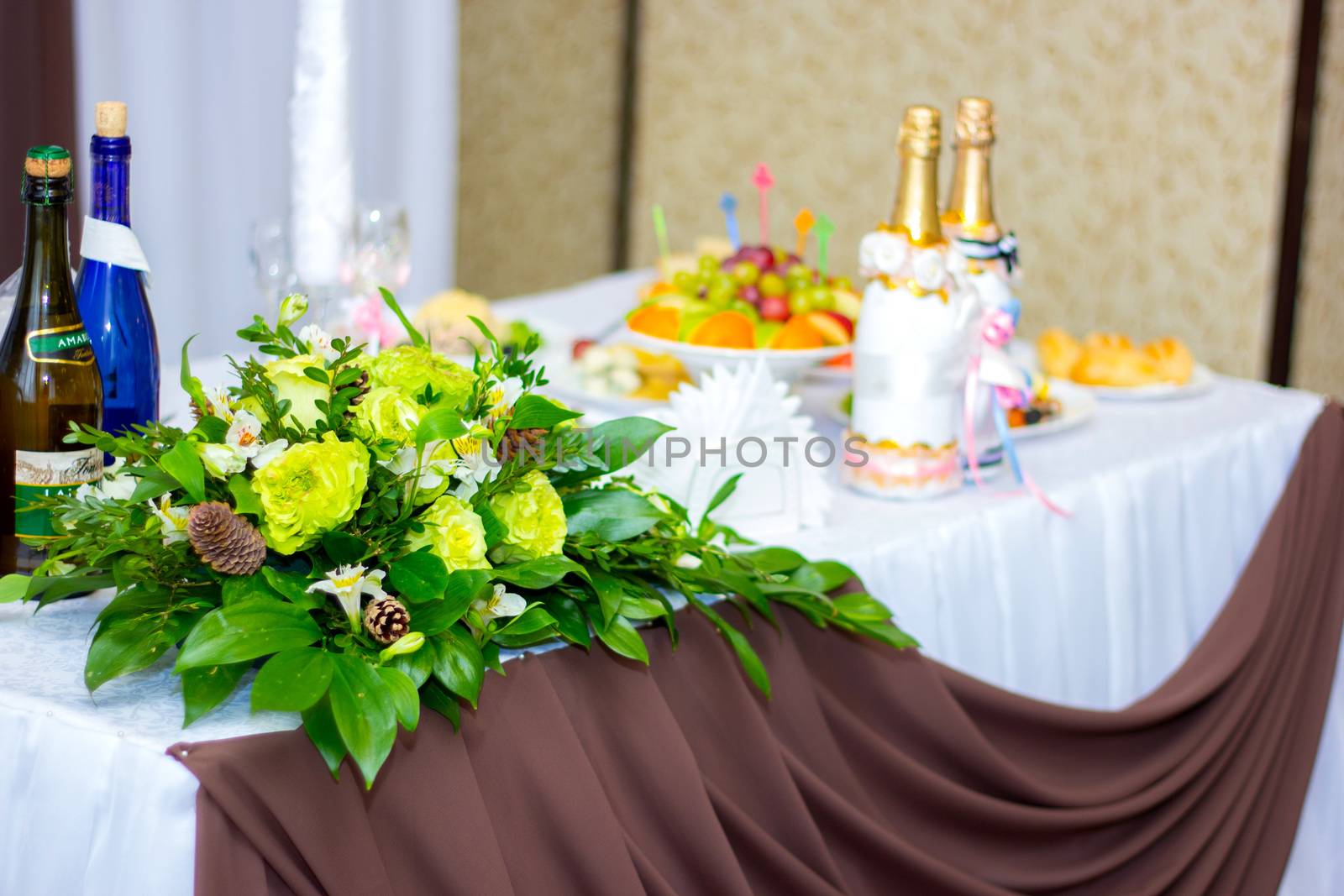 the wedding table decorated in flowers for newlyweds