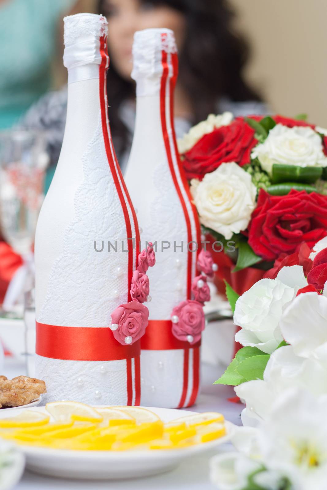 Two bottles of champagne decorated for a wedding