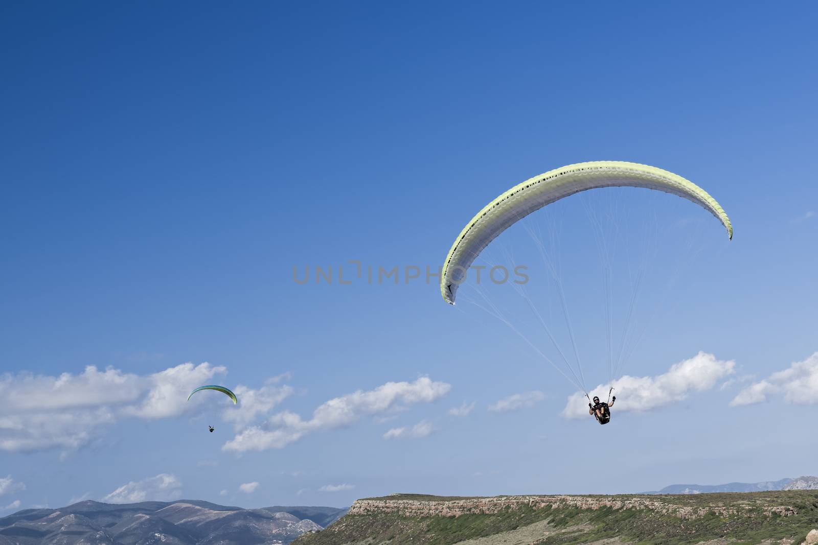 Colorful hang glider in sky over blue