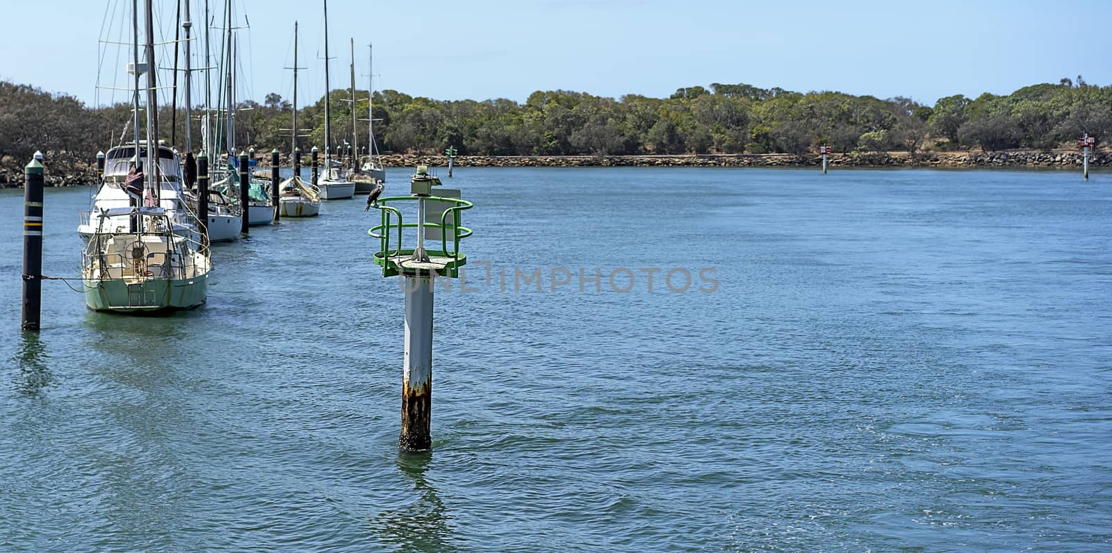 Mooloolah River with green starboard channel marker showing navigable water and moored yachts and boats