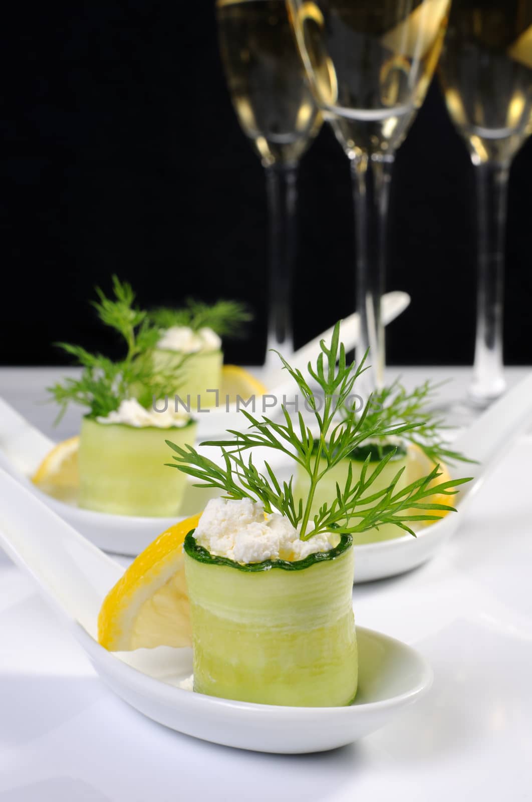 Cucumber canape with ricotta and lemon slice close-up. 