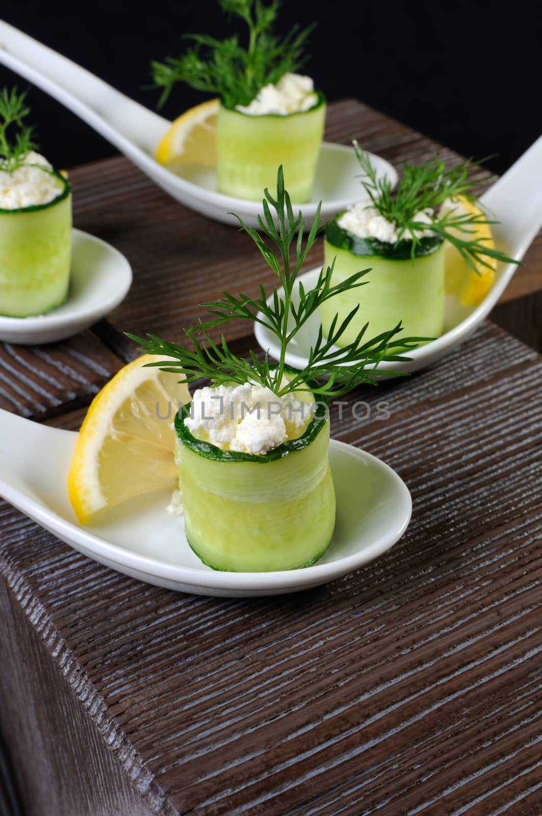 Cucumber canape with ricotta and lemon slice close-up. 
