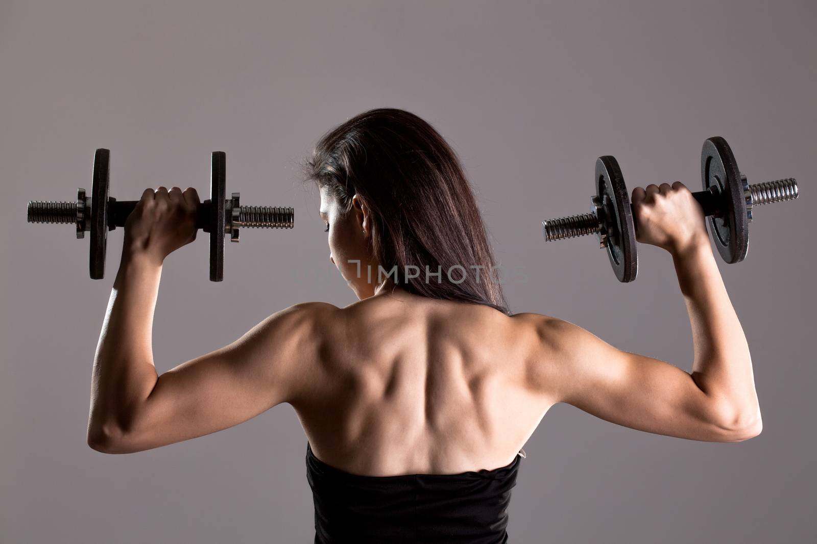 girl in sexy black dress lifting weights by kokimk