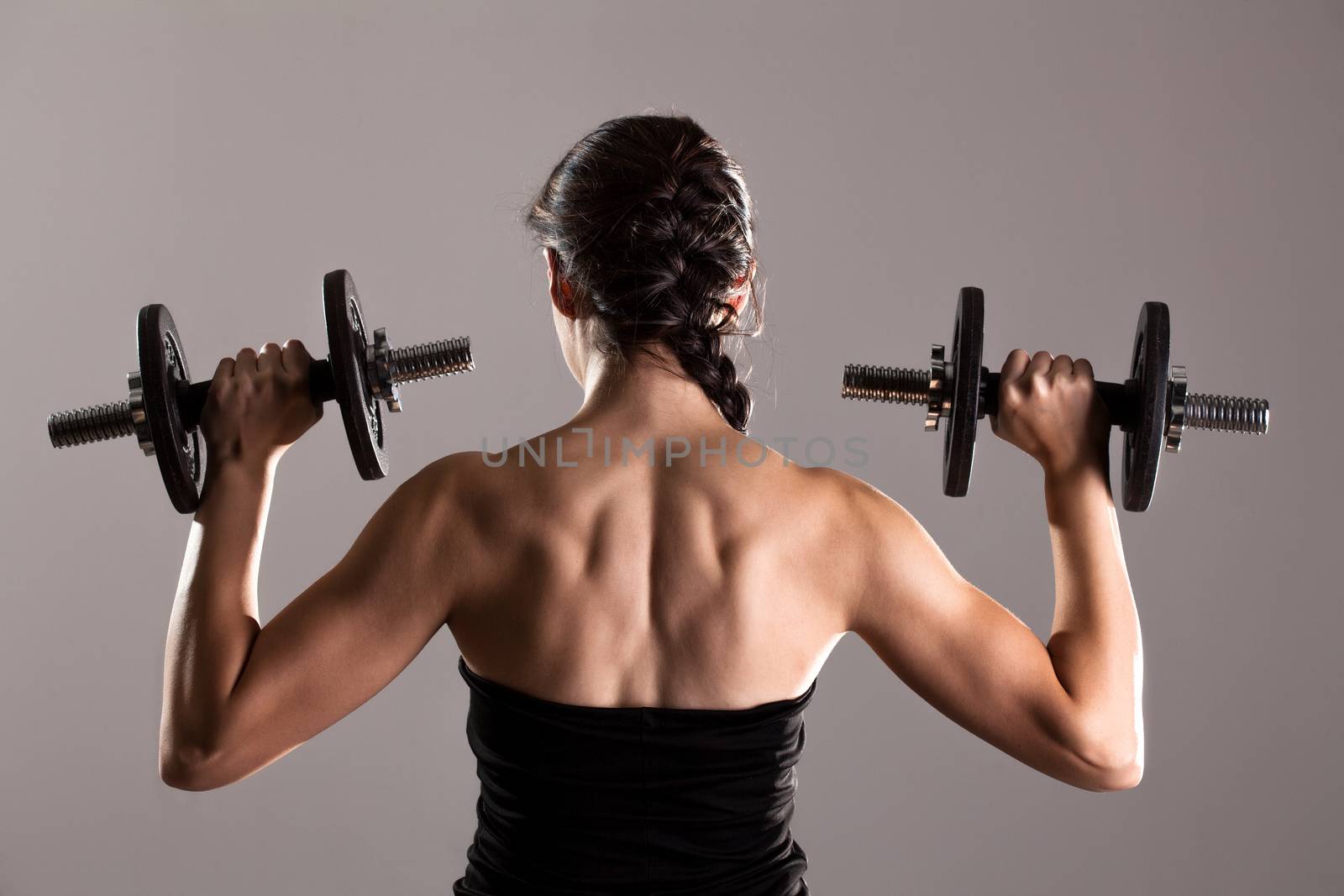 girl in sexy black dress lifting weights by kokimk