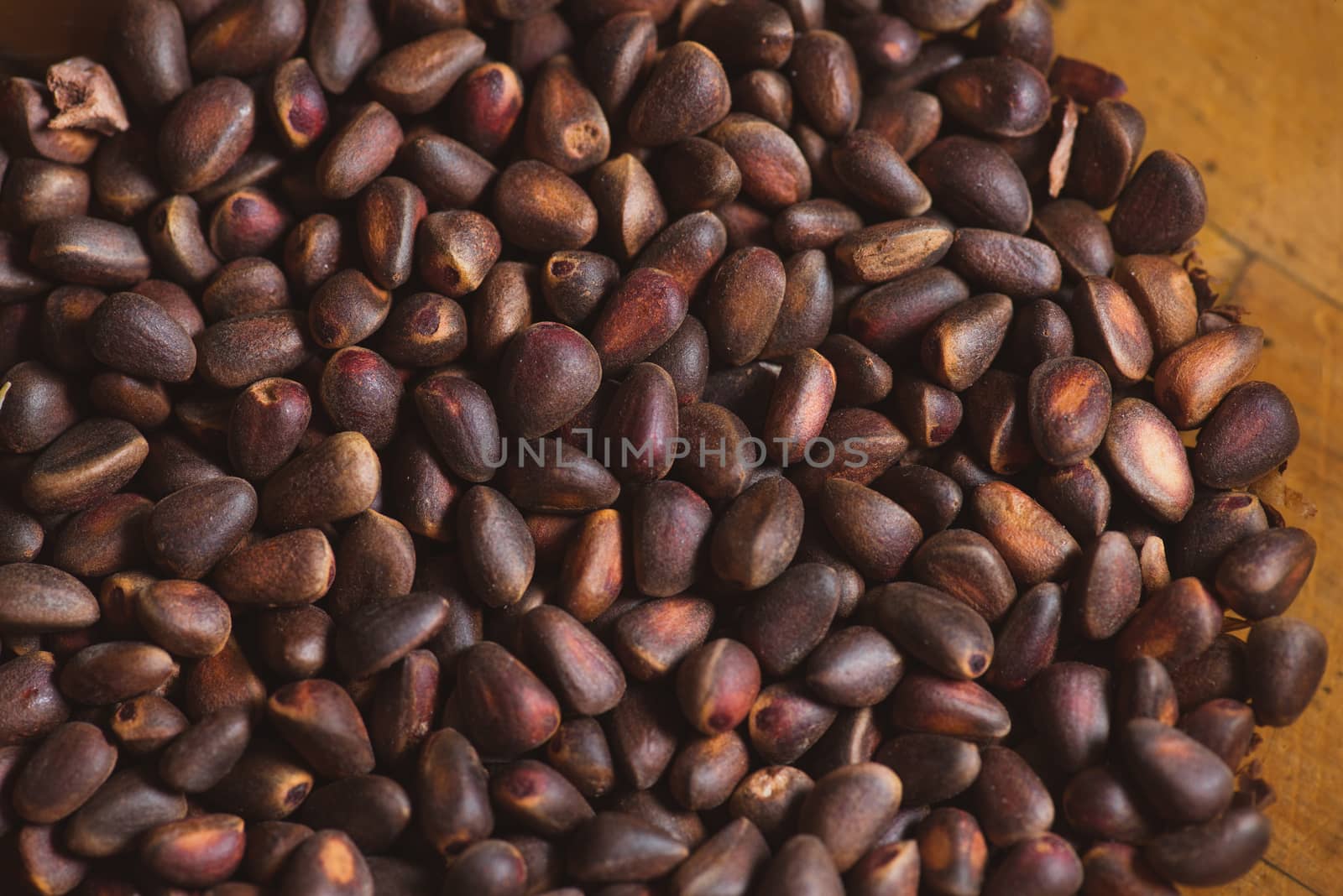 Pine nuts in shells of ciberian cedar as a background. Macro by skrotov