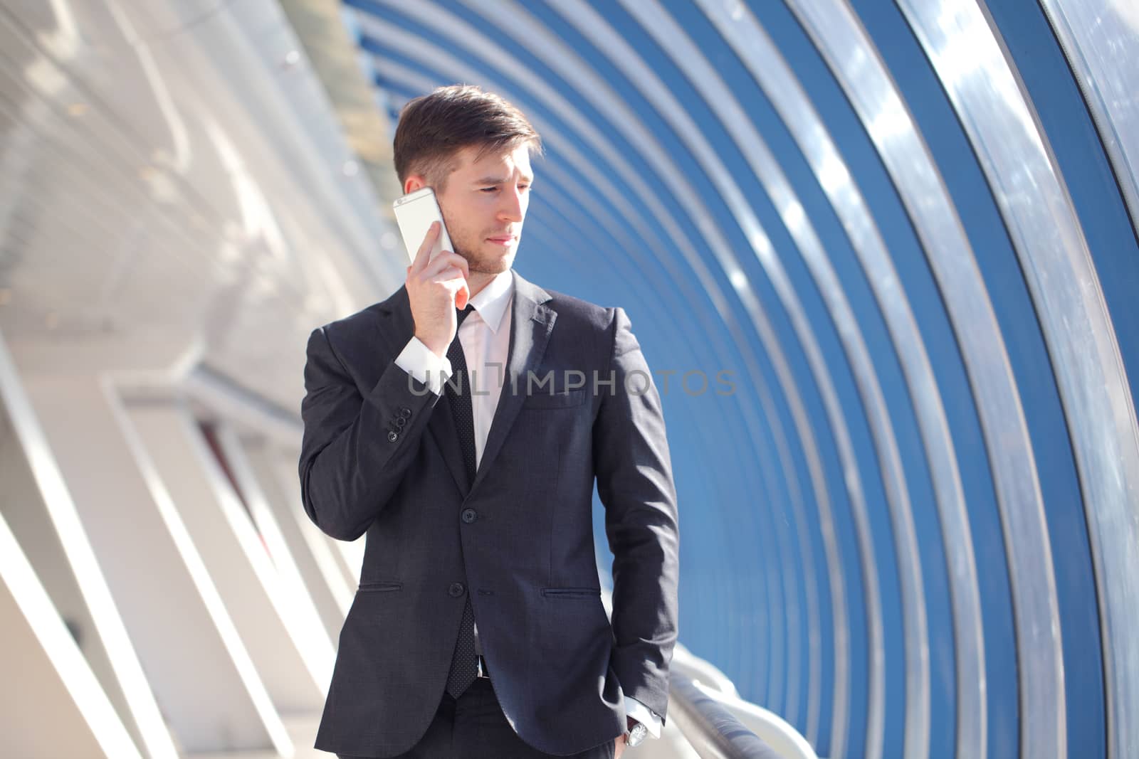 Businessman talking on the phone in modern building