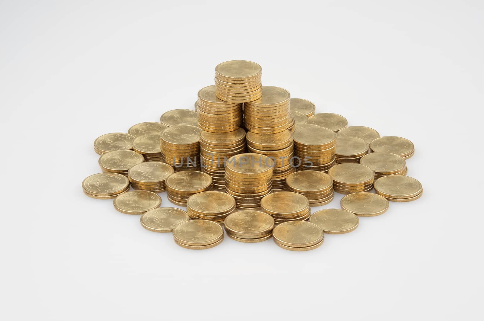 Pile of gold coins place as building on white background. 