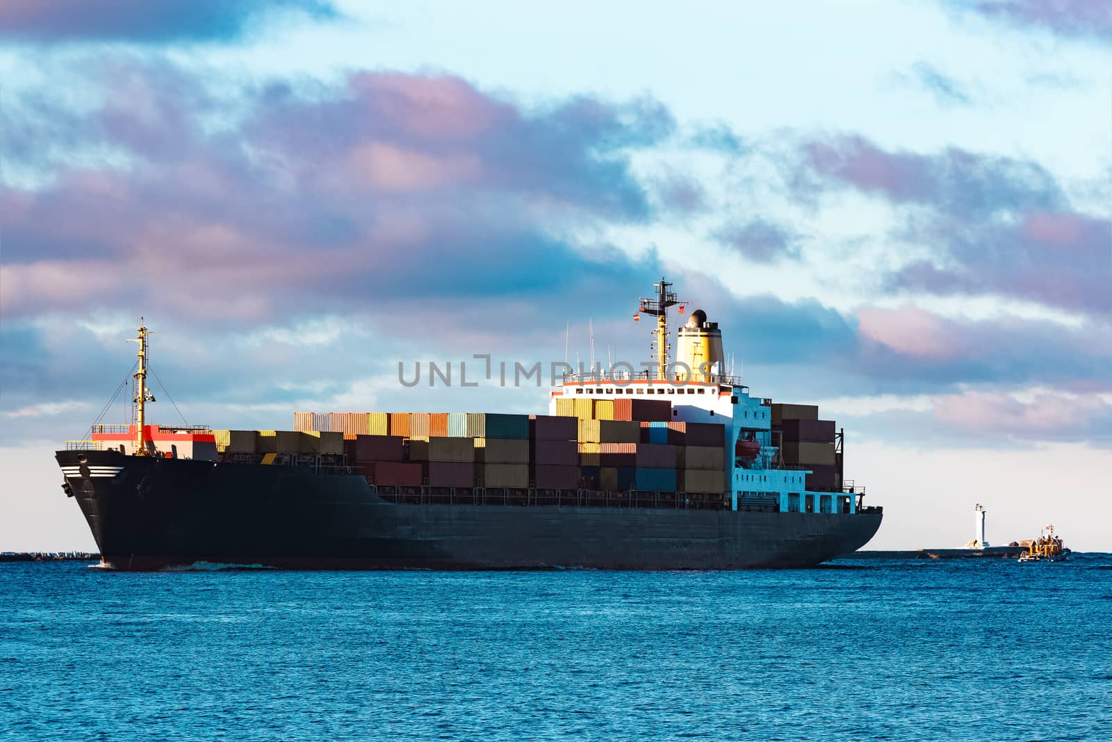 Modern black container ship moving from Baltic sea
