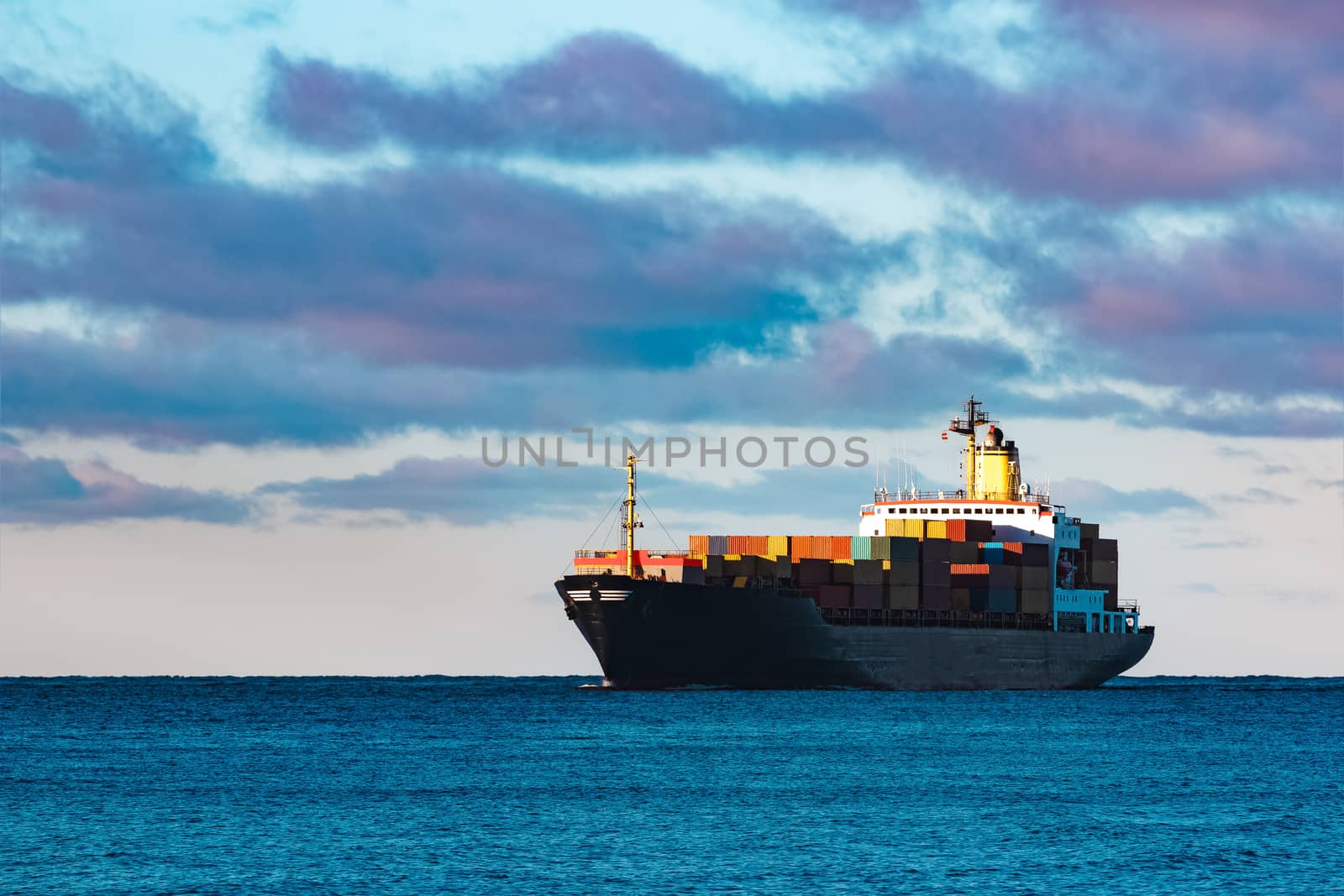 Modern black container ship moving from Baltic sea