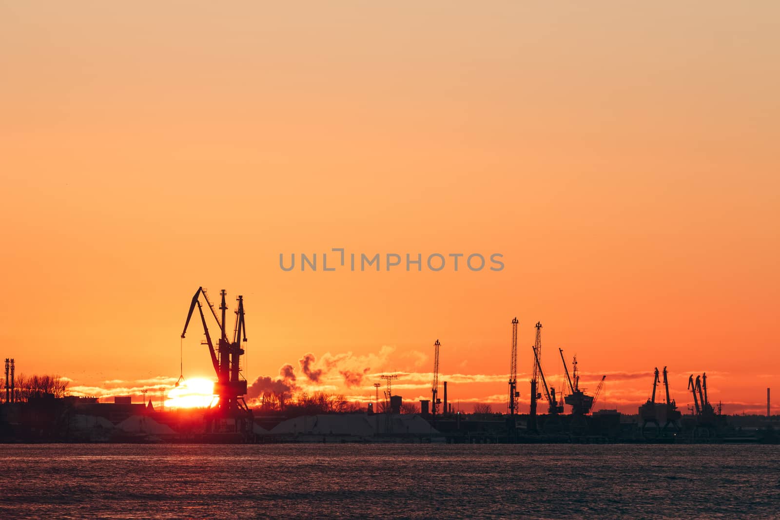 Hot winter sunrise over the cargo port in Riga