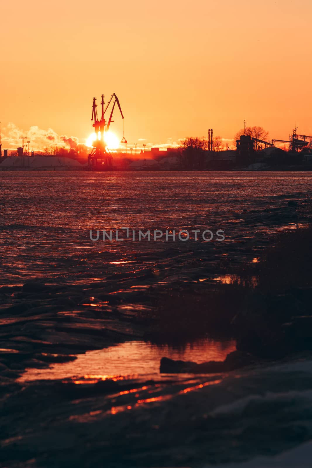 Hot winter sunrise over the cargo port in Riga