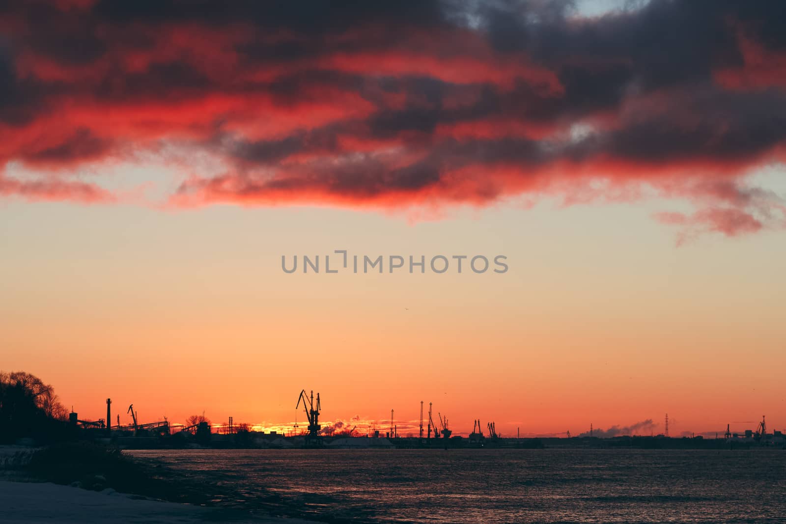Hot winter sunrise over the cargo port in Riga