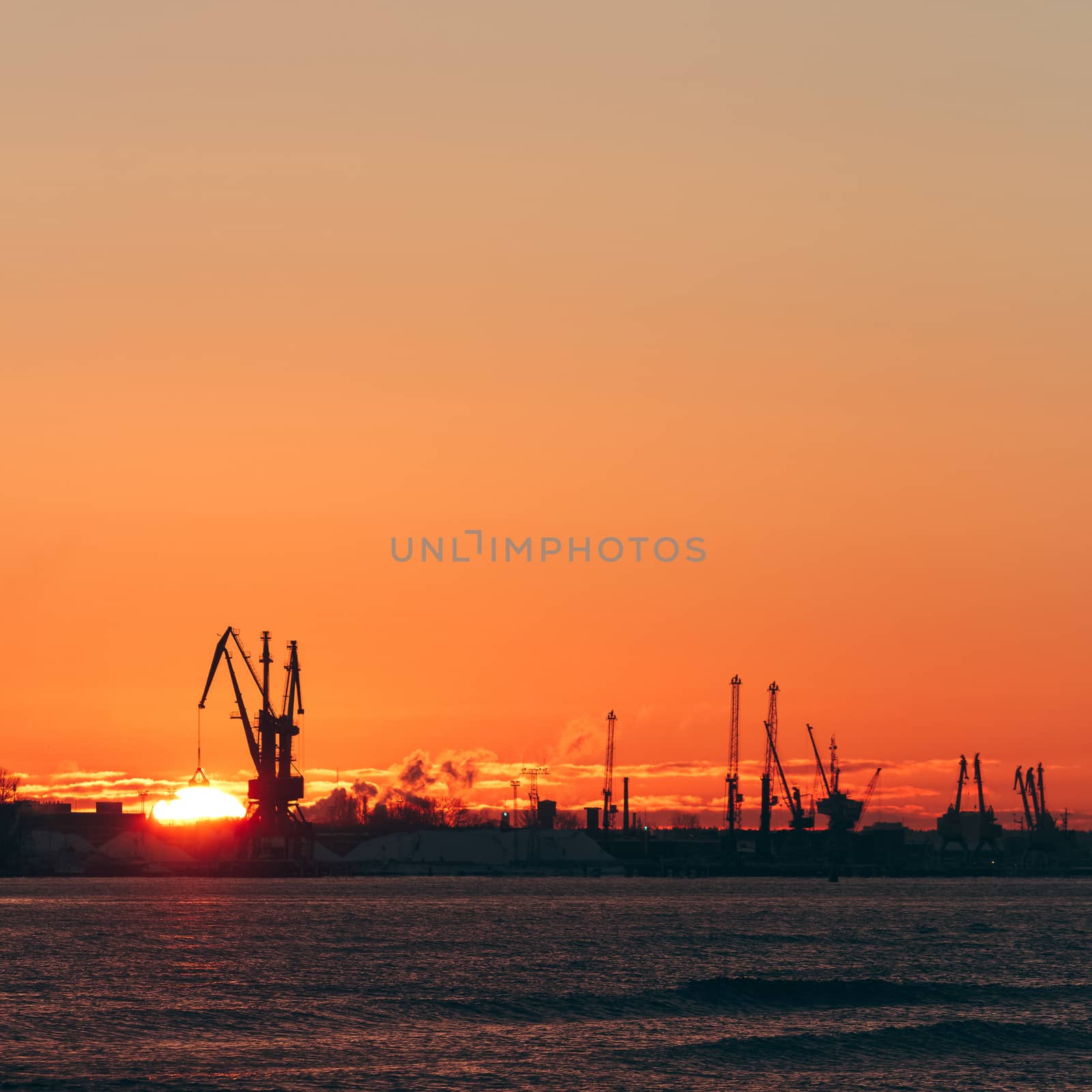 Hot winter sunrise over the cargo port in Riga