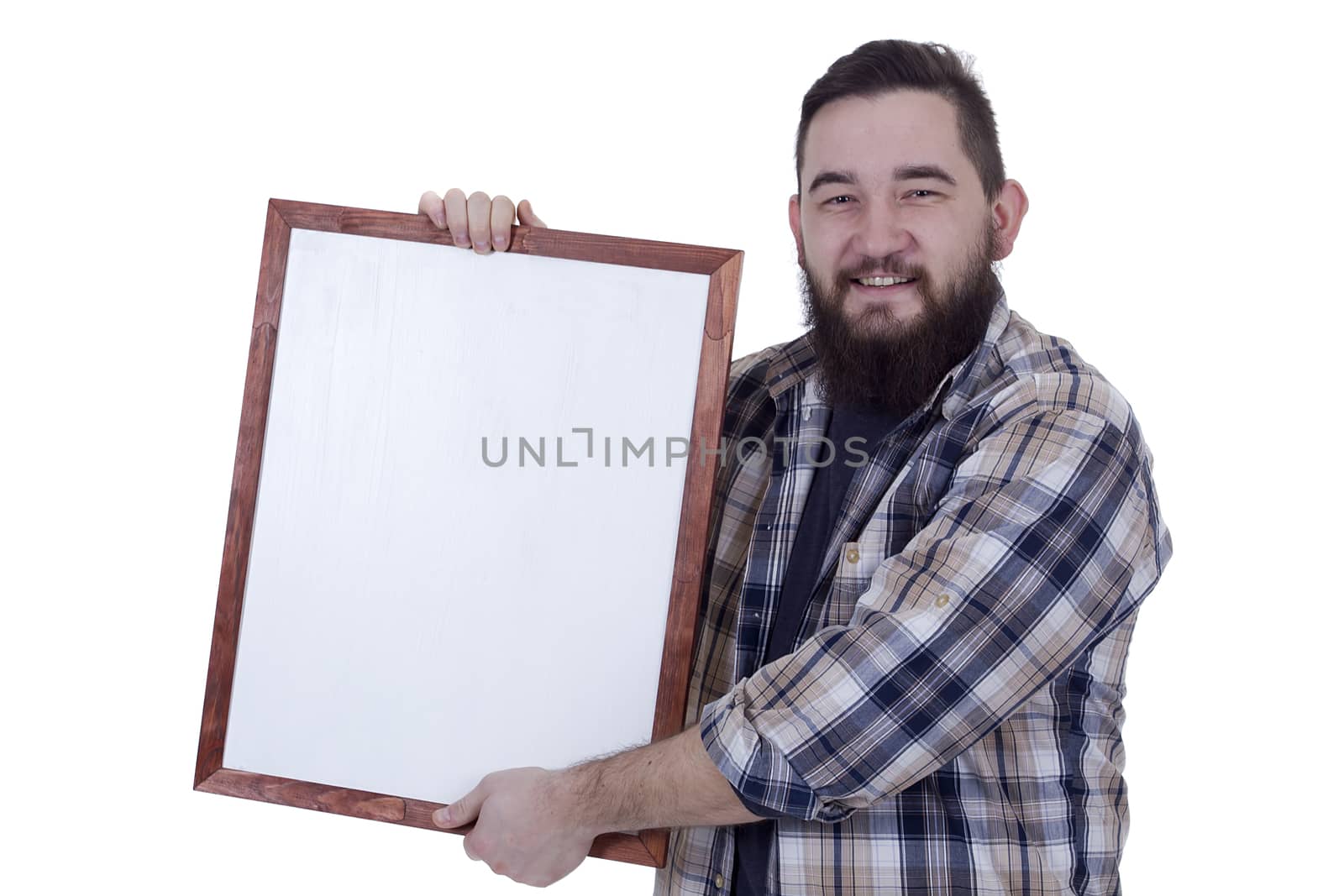 Smiling bearded young man with white board in hands