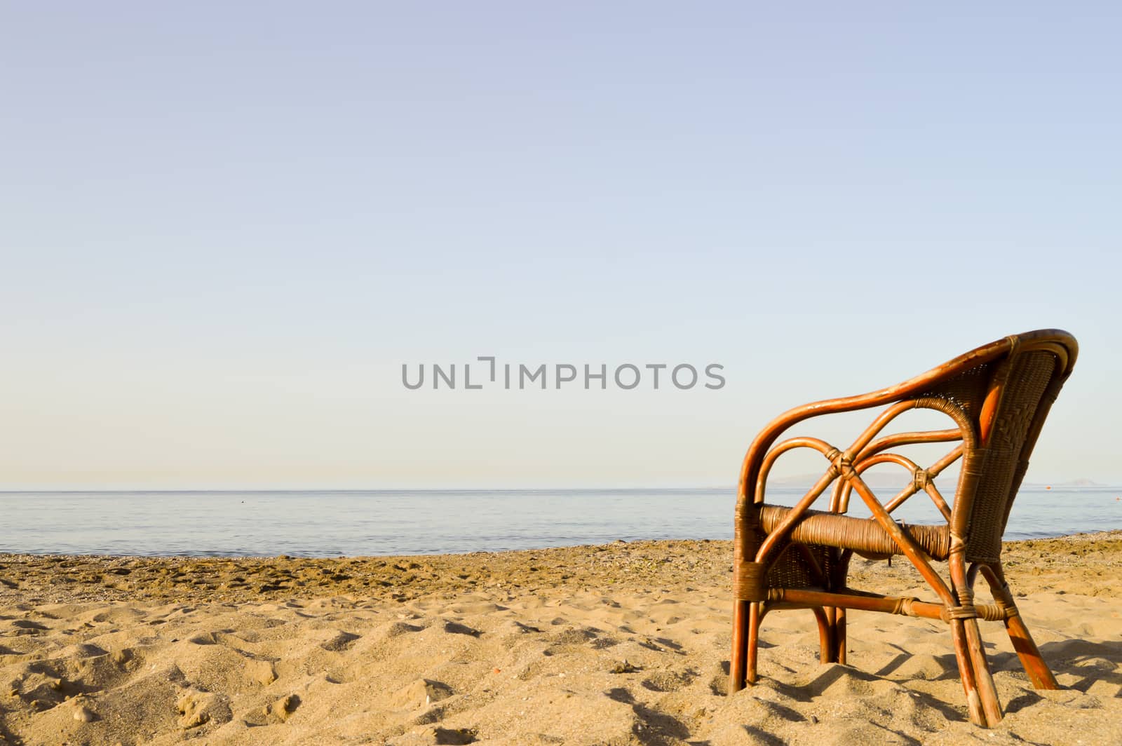 Wicker chair on Amoudara beach in Crete