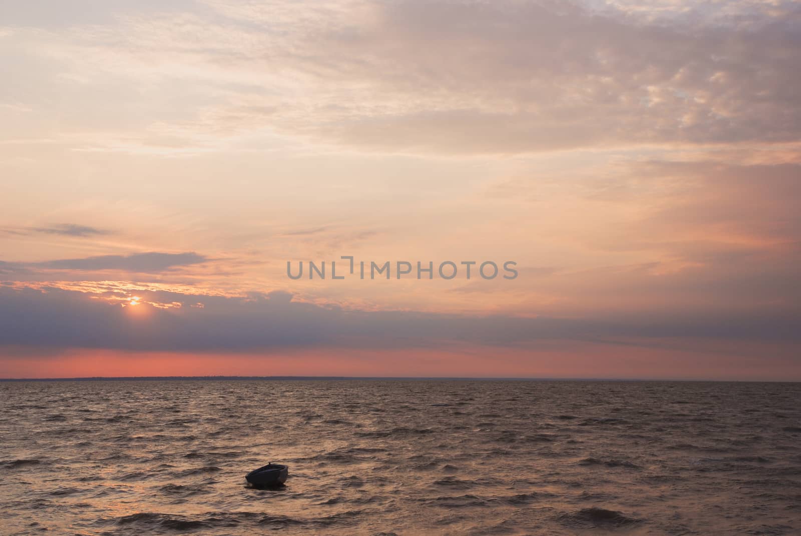the boat into the sea at sunset by skrotov