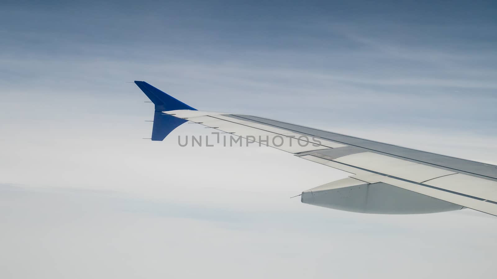 The airplane wing on the beautiful cloudy and sky.