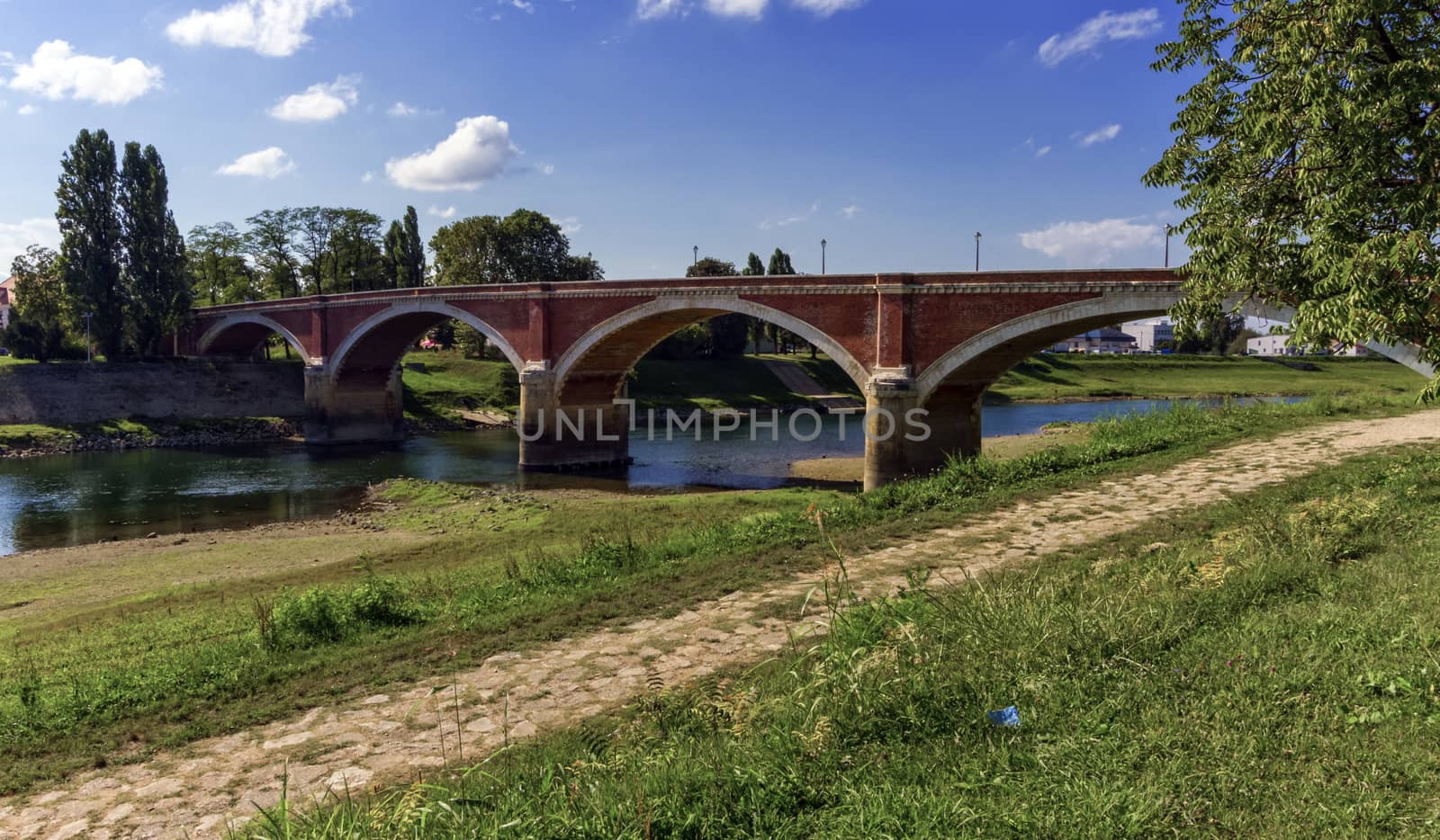 Old bridge over the Kupa river in Sisak, Croatia by Elenaphotos21