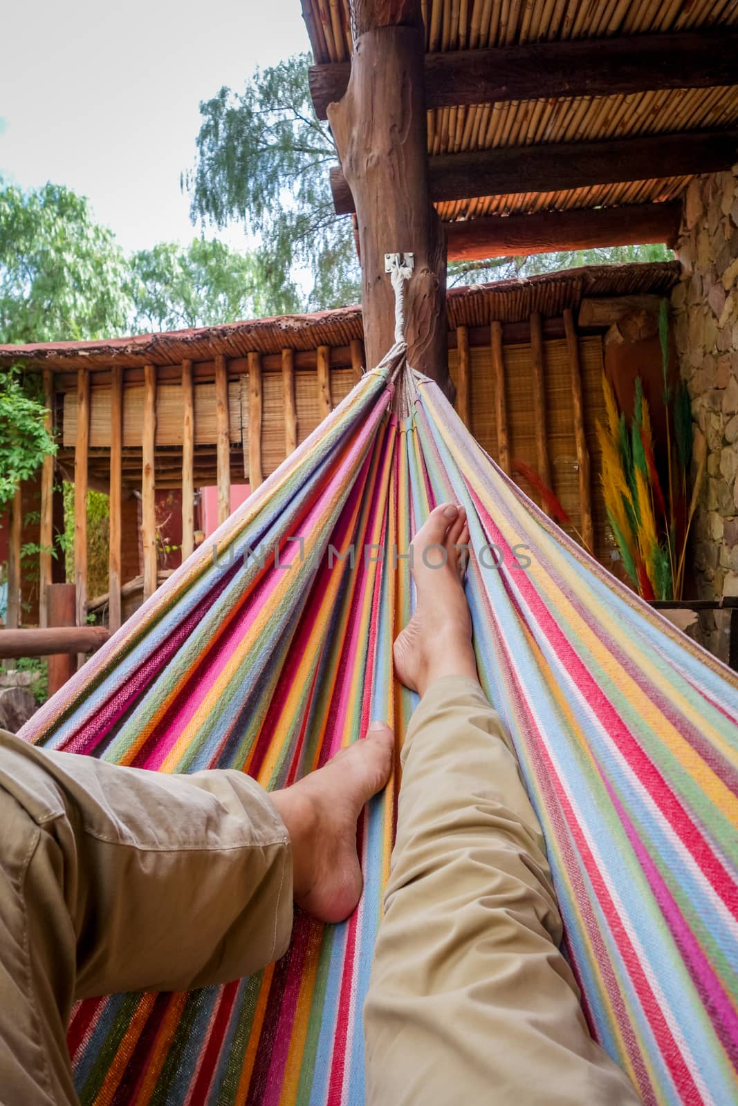 Man relaxing in a colored hammock. subjective view