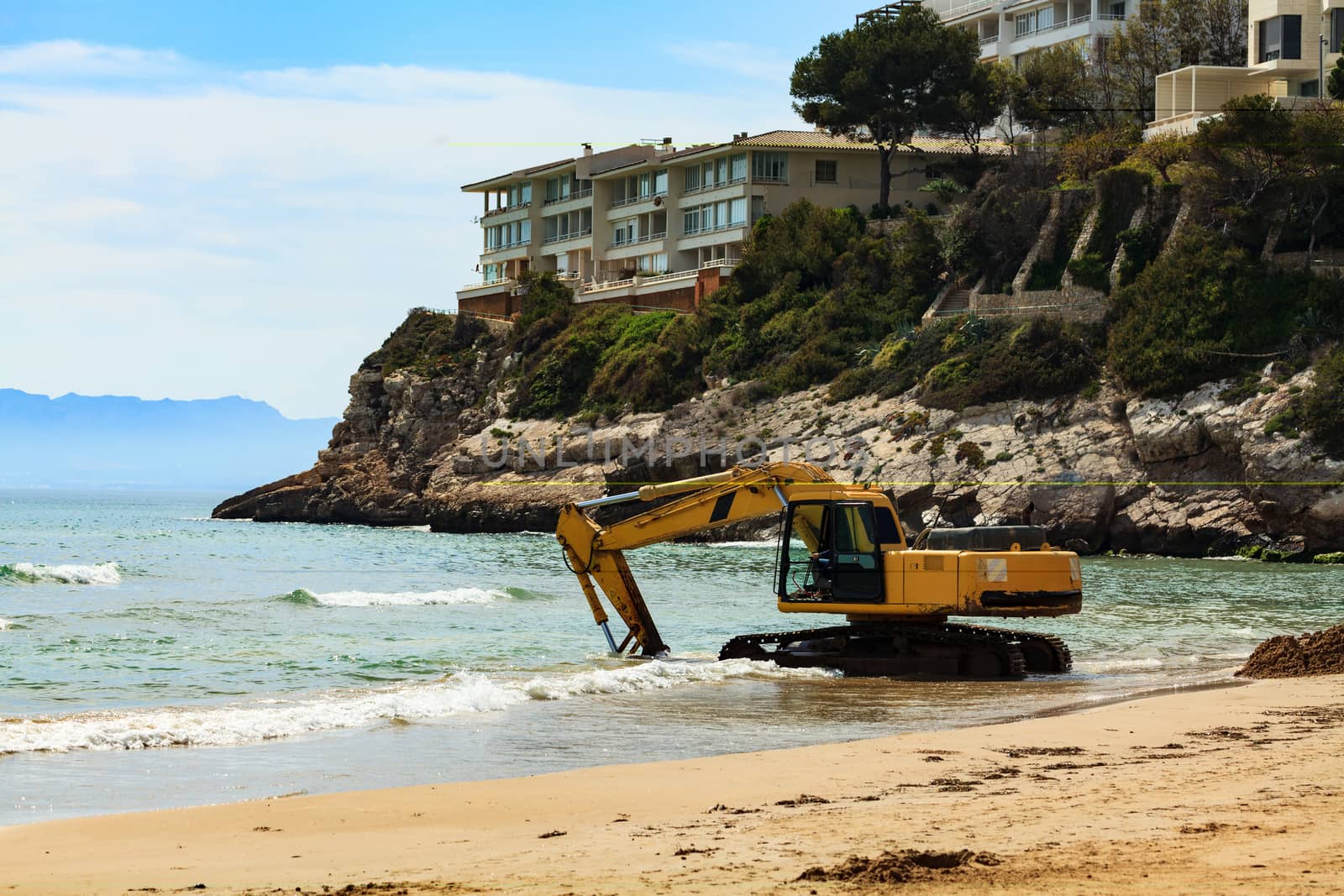 View of the empty beach with the excavator. Salou, Spain by Nobilior