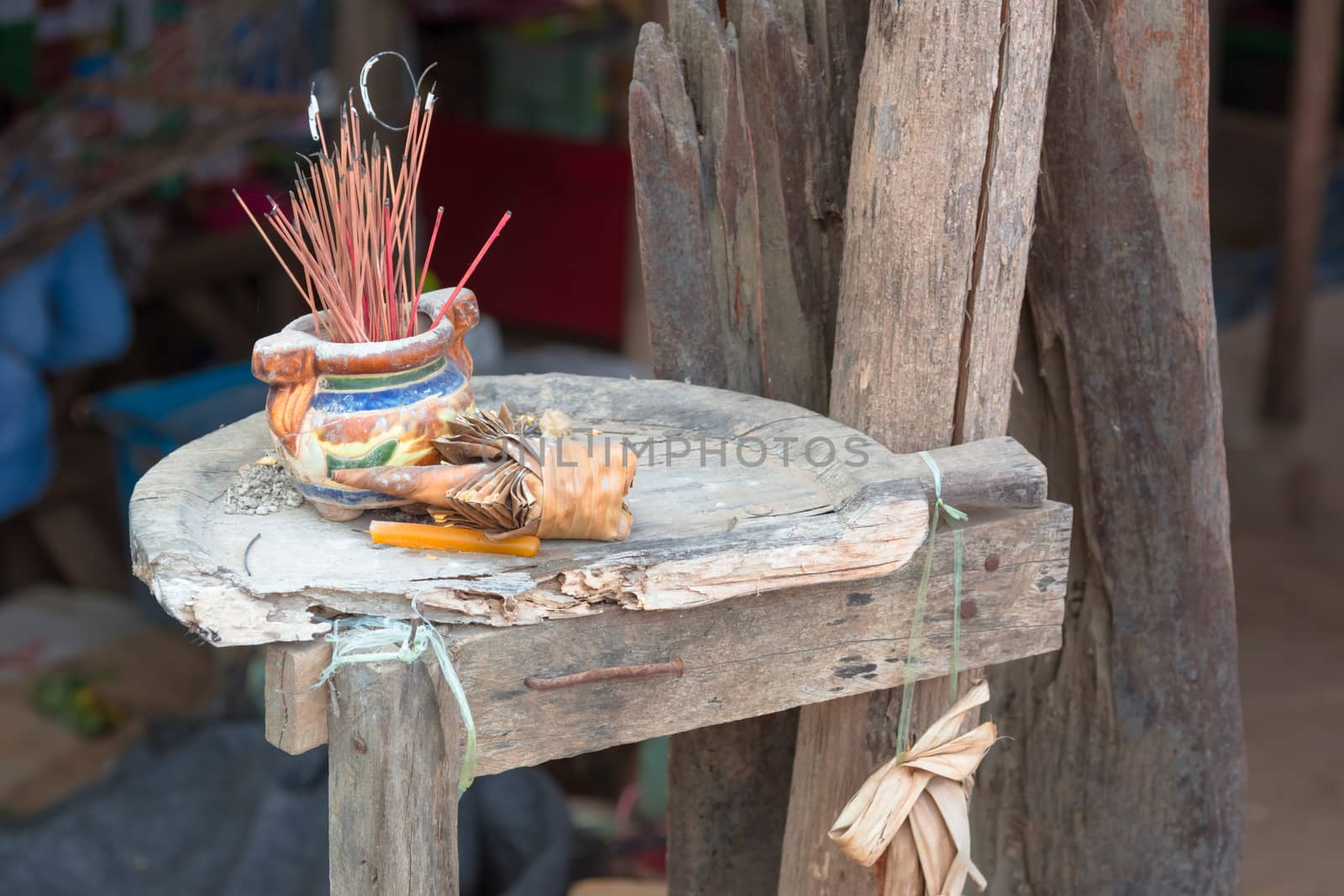 Burned red Incense stick in old joss-stick pot by ahimaone