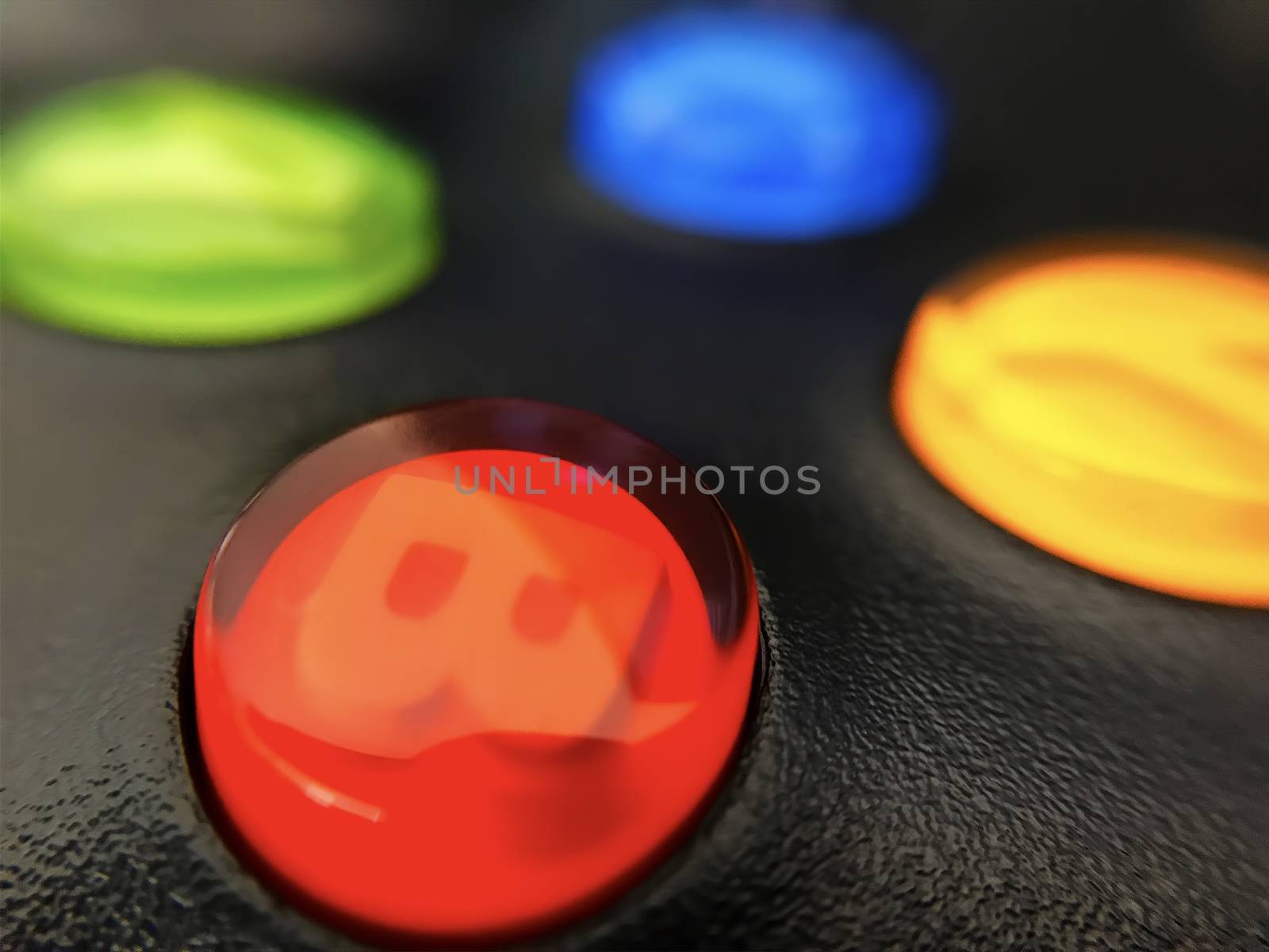 Illuminated buttons of a console gaming controller.