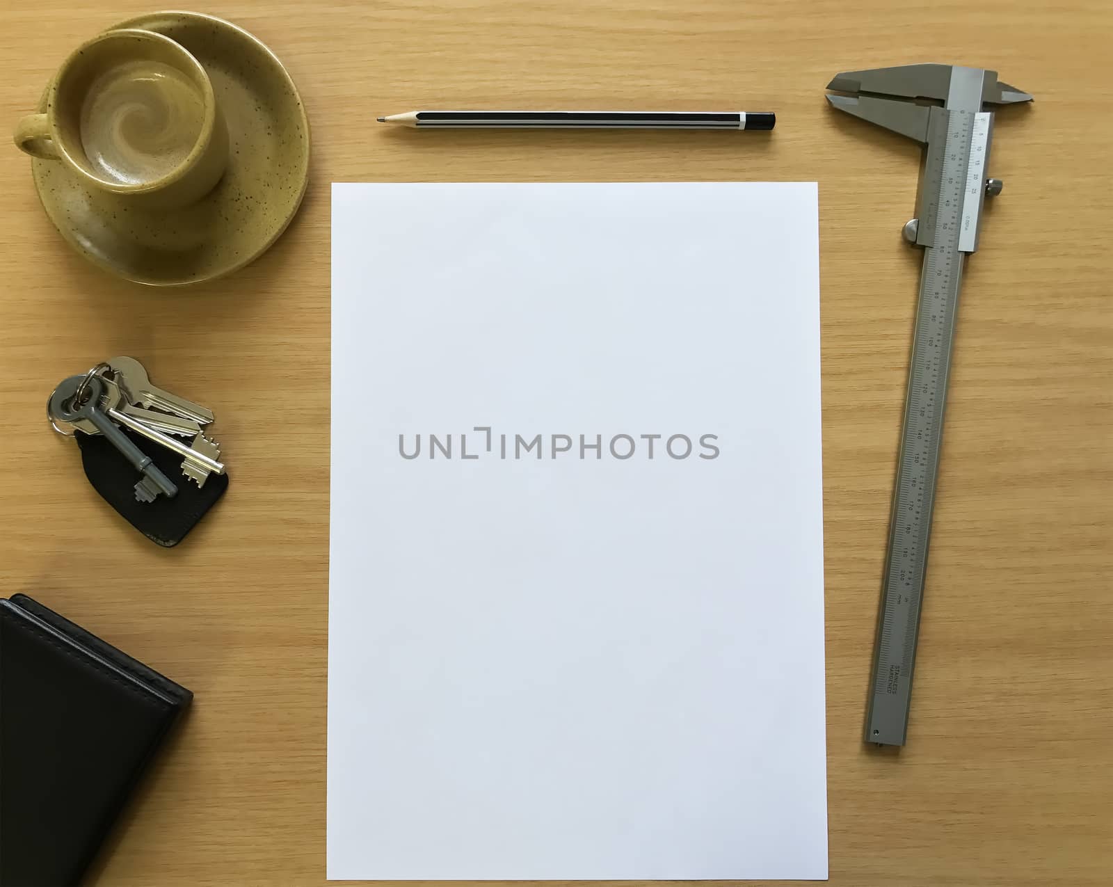 An espresso coffee, vernier caliper and blank paper.