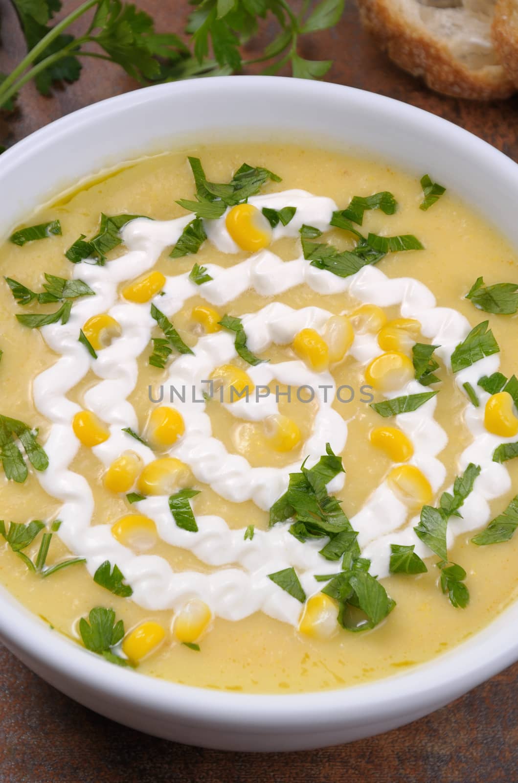 Puree soup mealies seasoned with grains of corn, parsley and sour cream